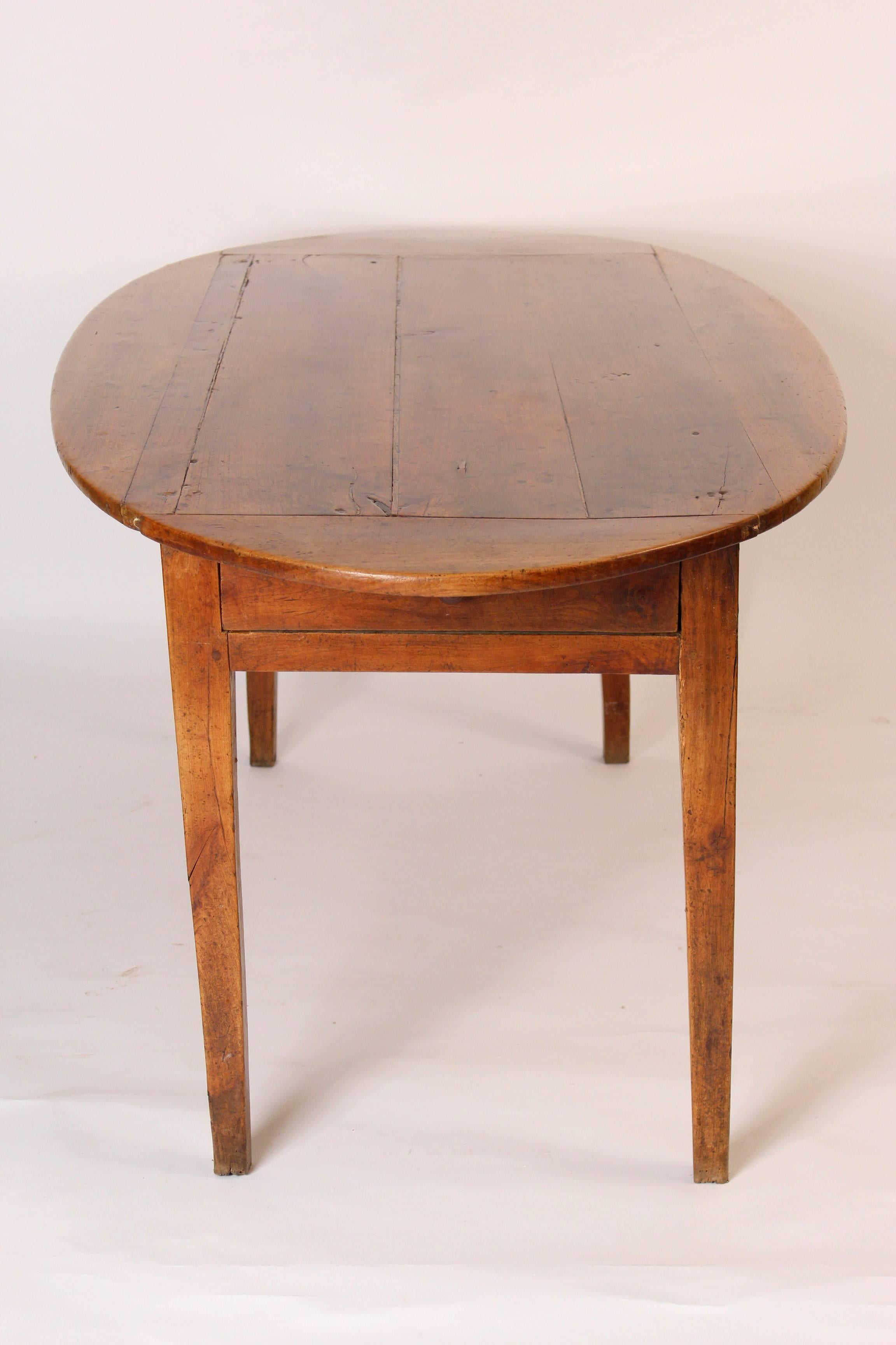 Directoire oval beech wood farm table with excellent color, early 19th century.
 