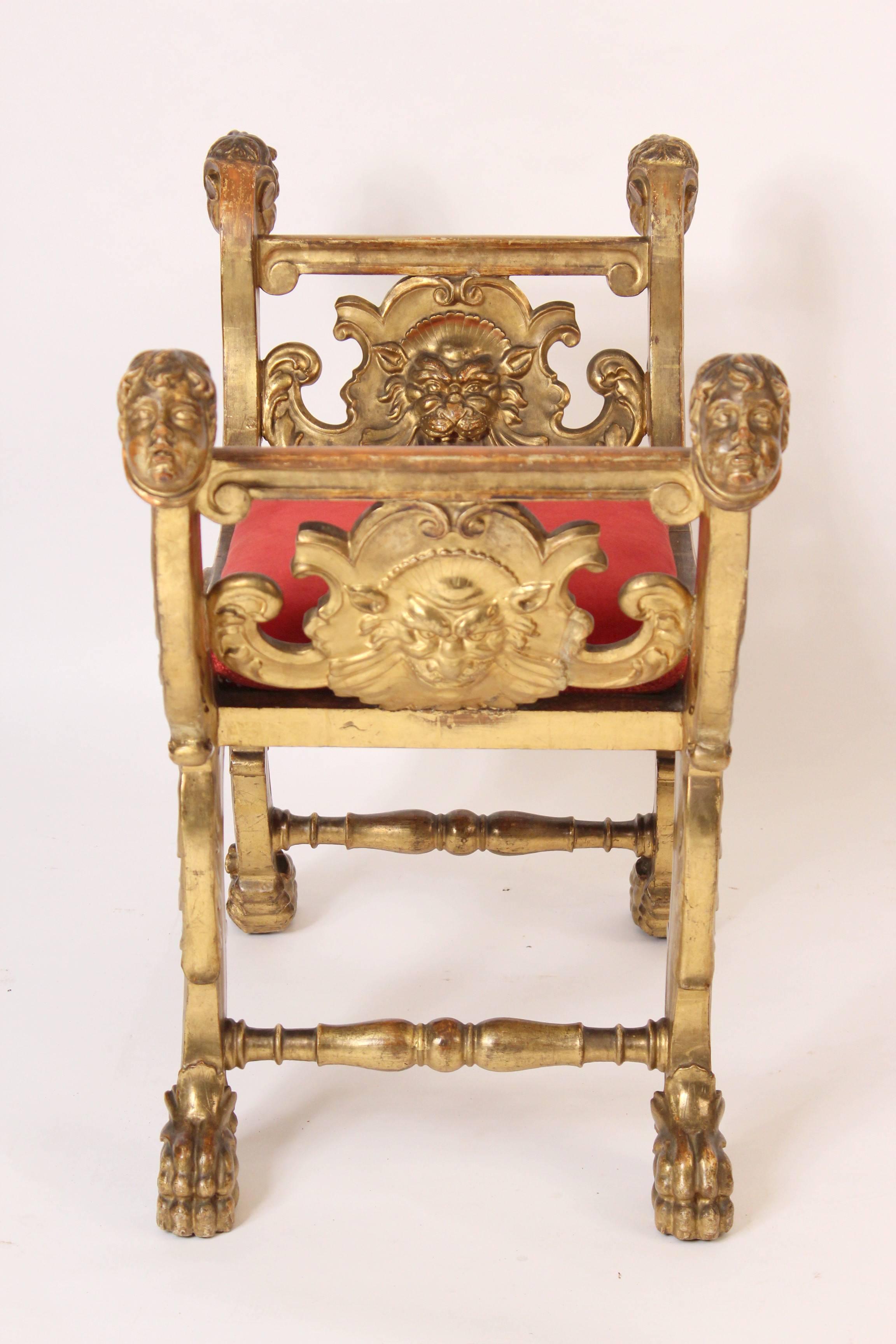 Banc en bois doré de style Renaissance, vers 1920. Ce banc présente une dorure d'excellente qualité, des têtes de cupidons sculptées, des visages de gargouilles et des pieds à pattes.