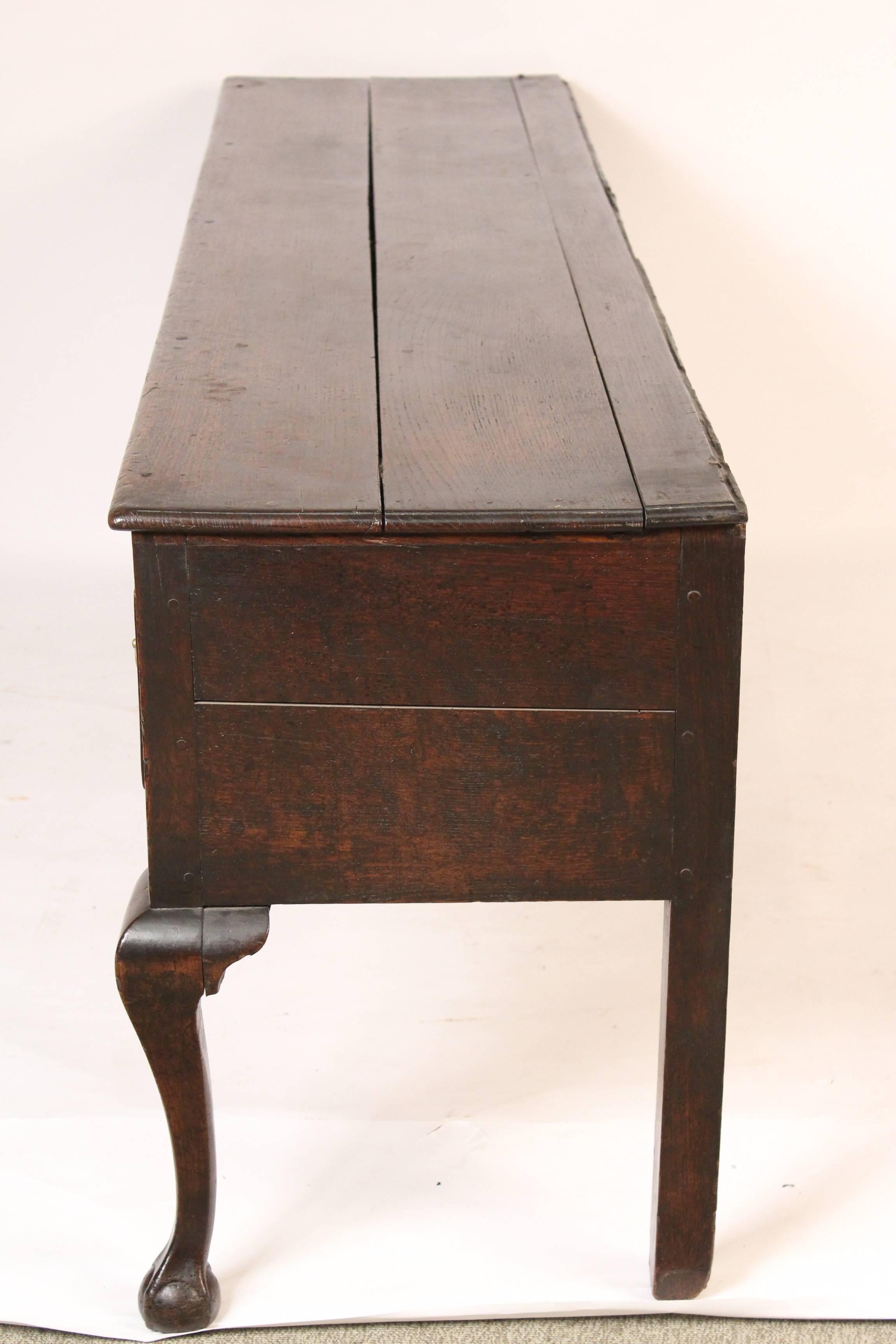 George II oak dresser base with cabriole legs and ball and claw feet, mid-18th century.