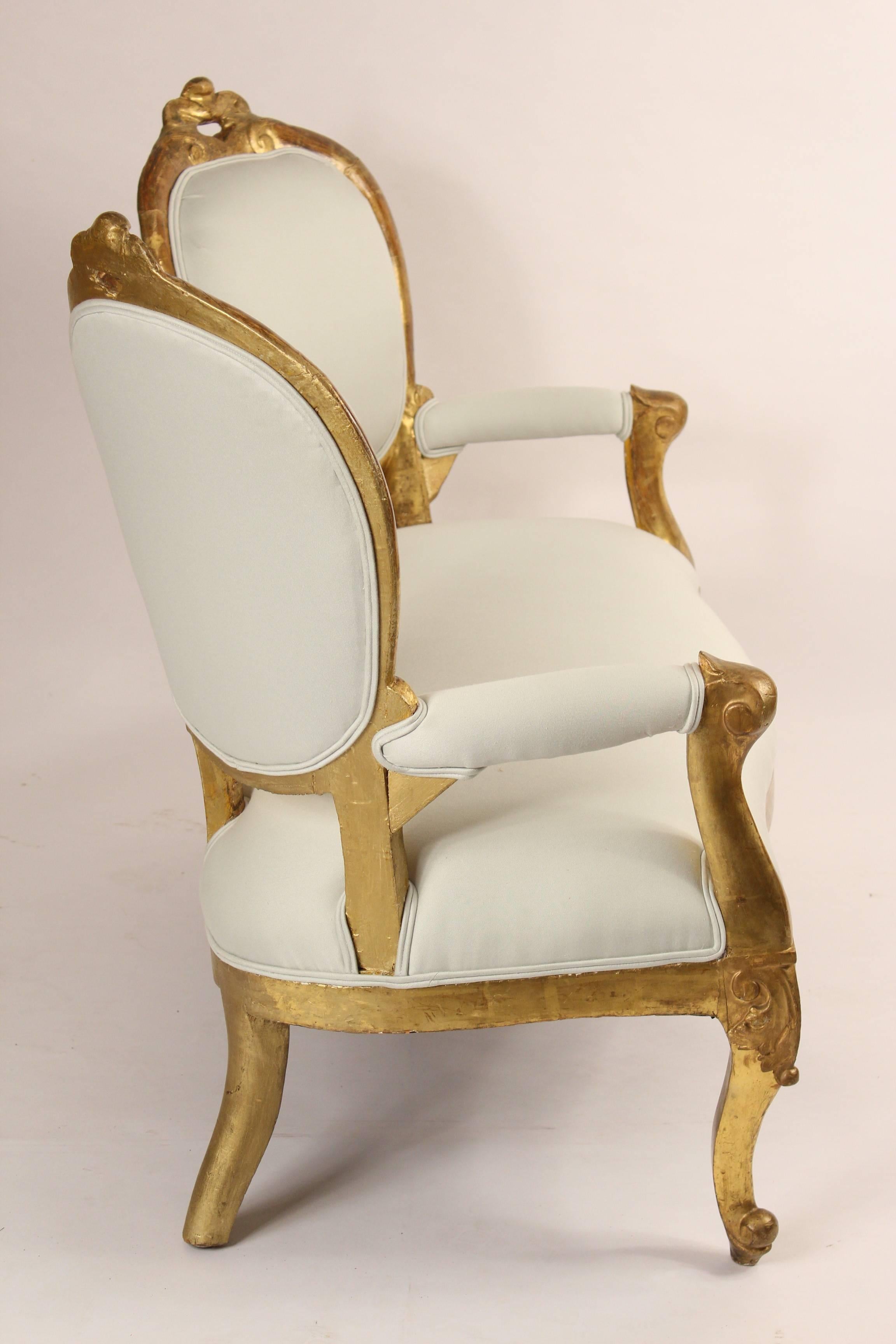 Napoleon III Venetian giltwood two chair back settee, 19th century. Very decorative and unusual design on this settee. With original gold leaf finish on the front and sides, the back side is painted.