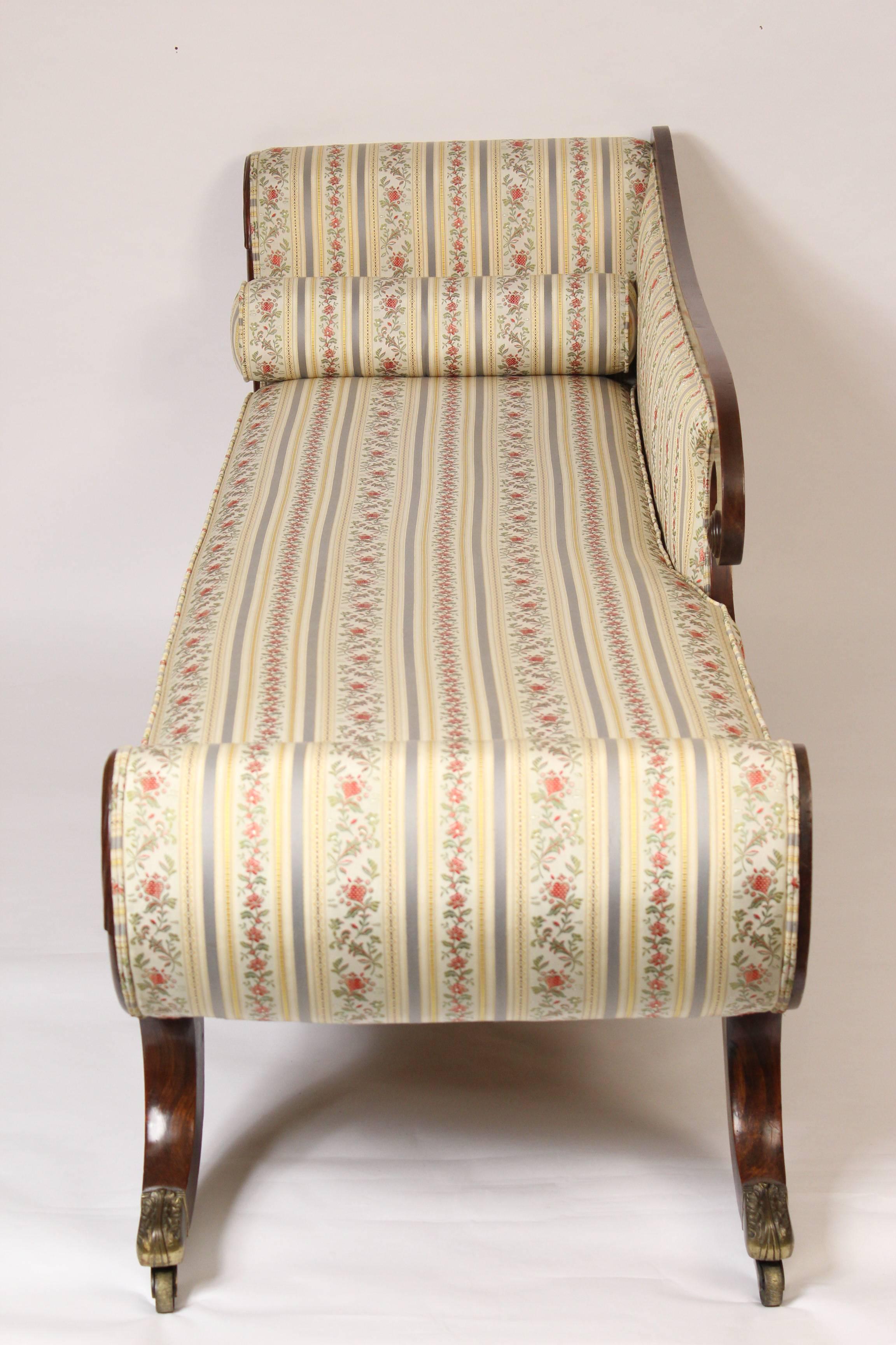 English Regency rosewood and mahogany recamier with brass feet and casters, early 19th century.