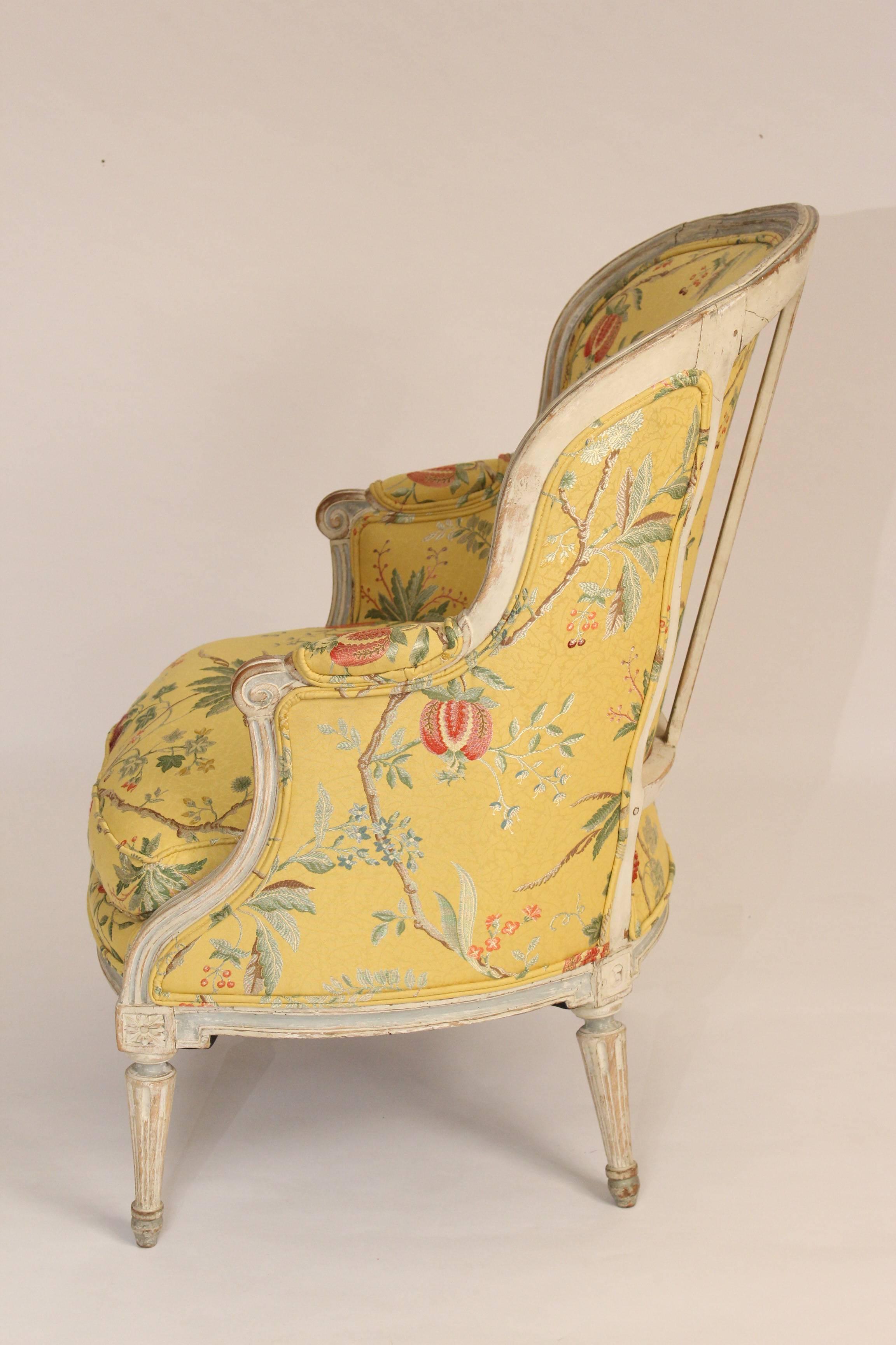 Louis XVI style painted bergere, 19th century. The color on the chair frame is grisaille / blue / white. The chair was recently upholstered, the upholstery is in excellent condition. The seat has down in it. The construction on the chair frame is