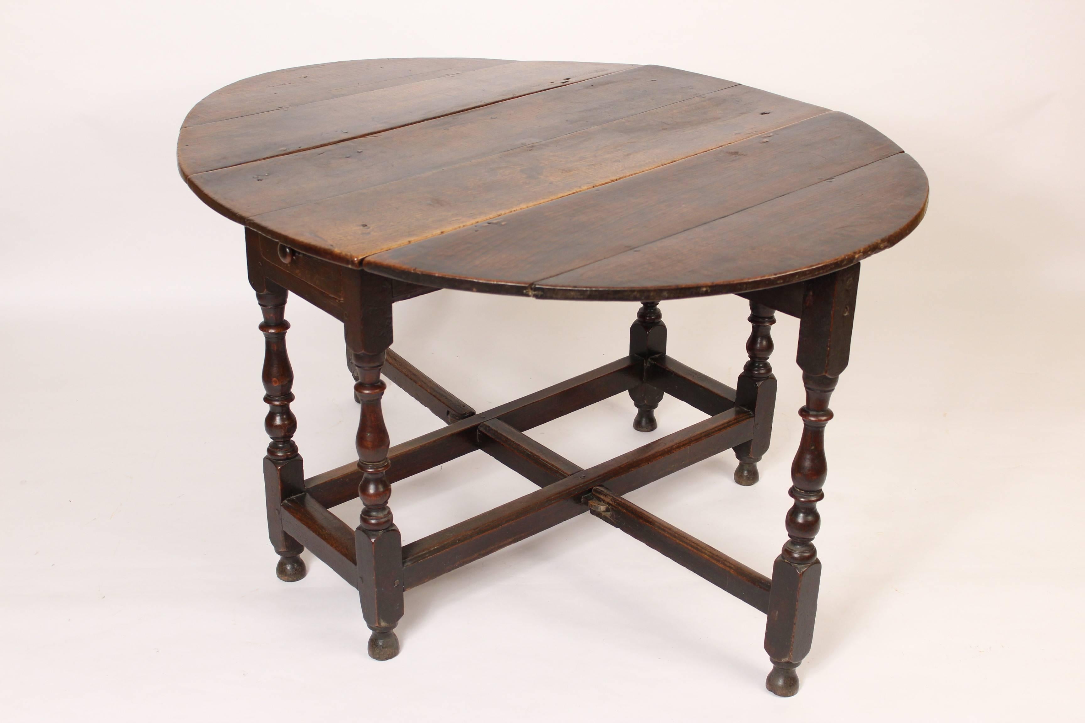Antique English oak fate leg table, 19th century. This table has very nice color / patina. Dimensions when the drop leafs are raised, height 27.25