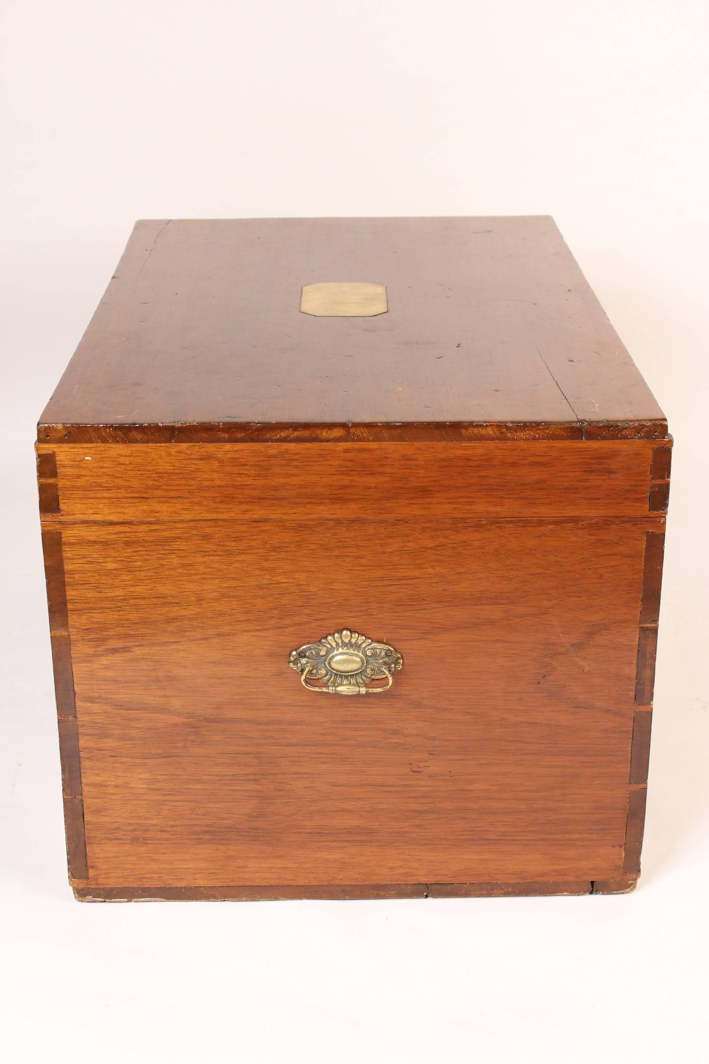 Camphor trunk with brass hardware, circa 1900. This trunk has a brass inlaid top, brass handles on each end and hand dovetailed construction. This trunk would be ideal for either a side table or coffee table.