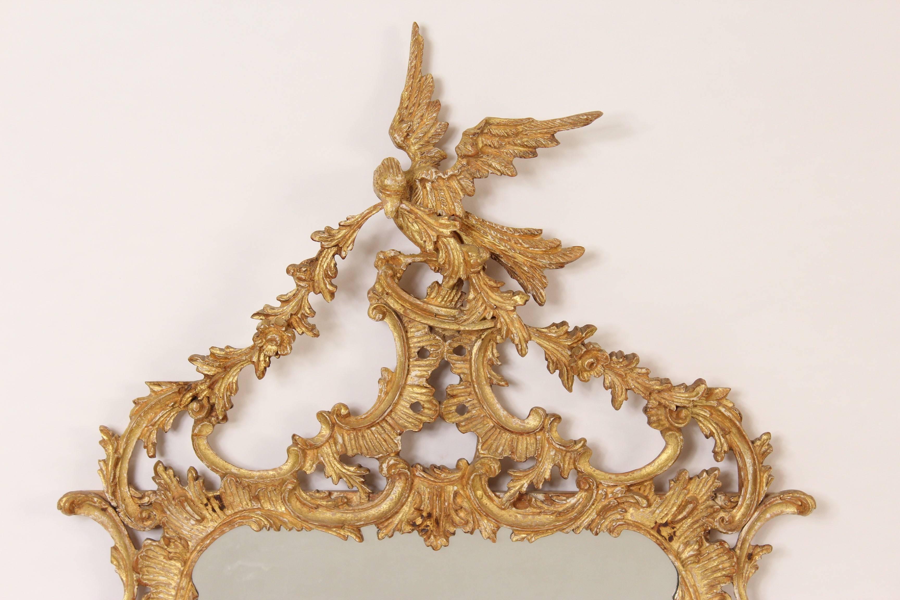George II style giltwood mirror, made in Italy, circa 1970. There is a sticker on that back indicating that it was made for Le Barge. There is also a sticker that says Italy.