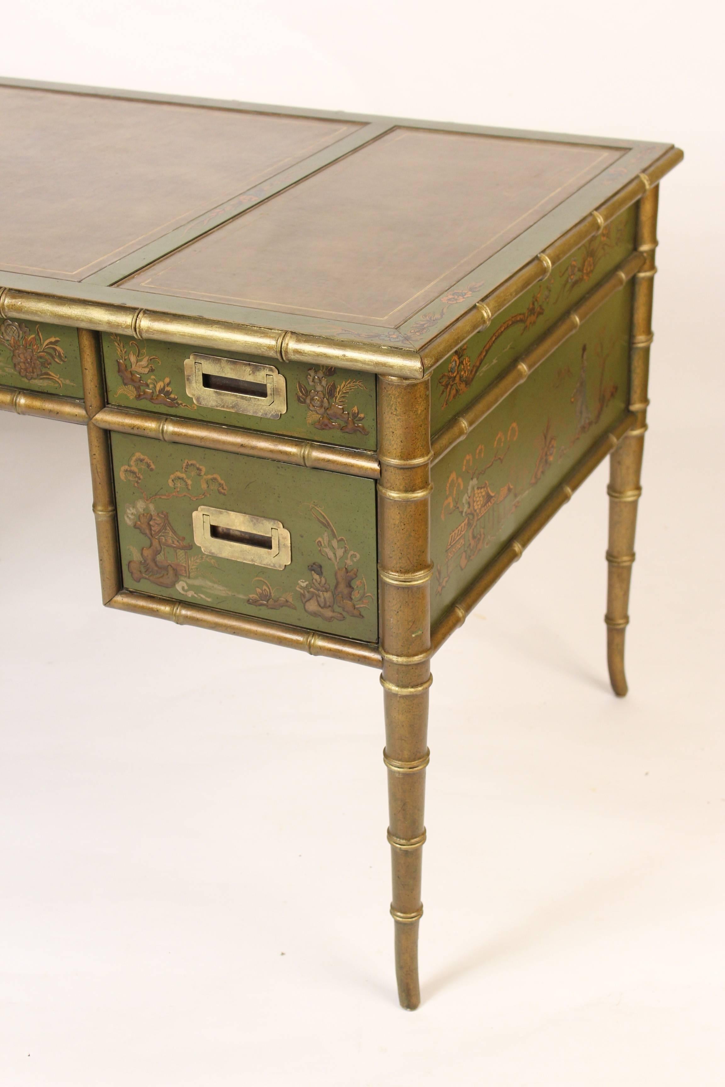 English Regency style chinoiserie decorated desk with Campaign hardware and a leather top, circa 1980s. Attributed to Drexel.