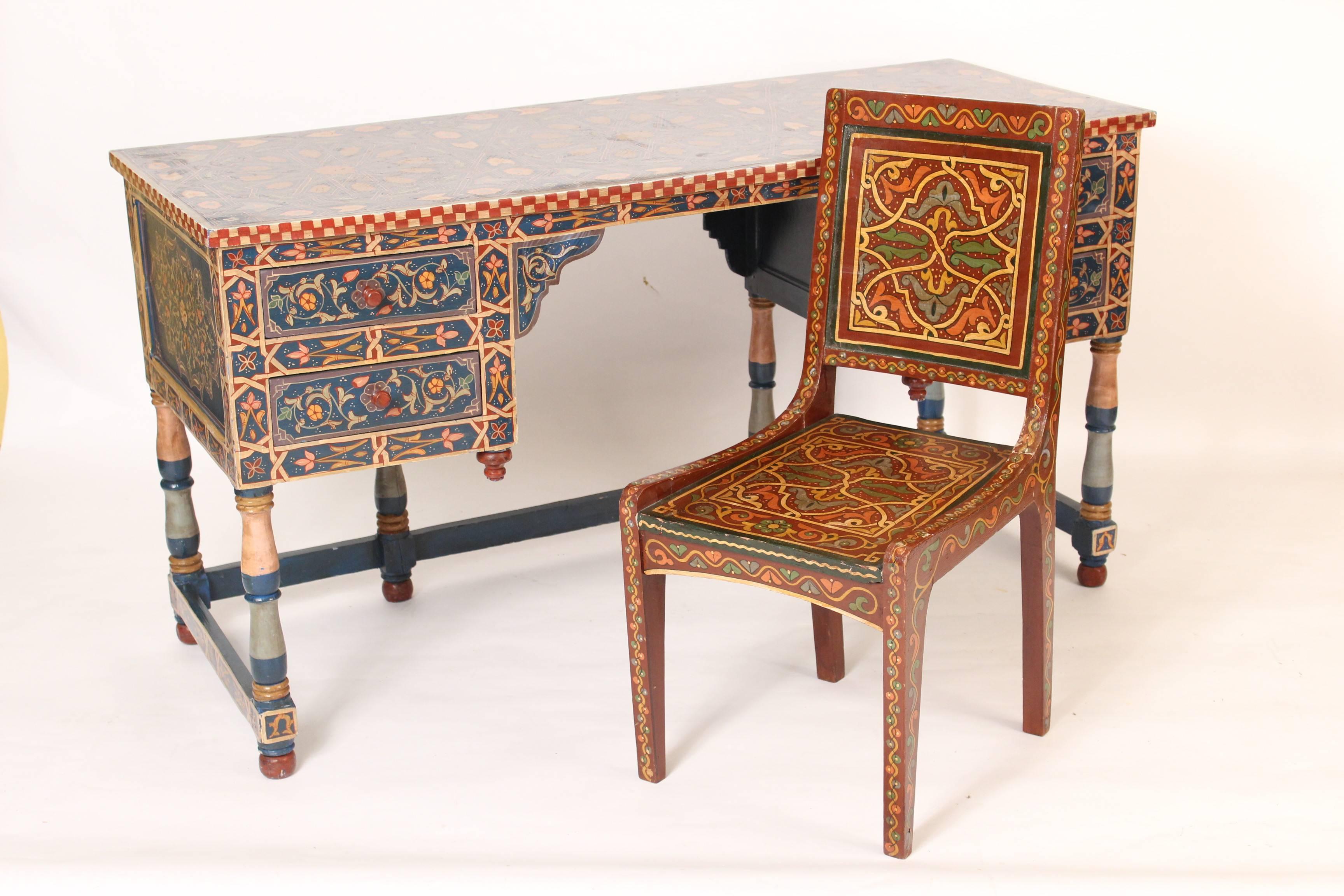 Colorful Moroccan style painted knee hole desk, late 20th century. There is also a chair that is included in the price of this desk. This is a very colorful desk that is decorated on the back side so it can float in the center of a room. This is a