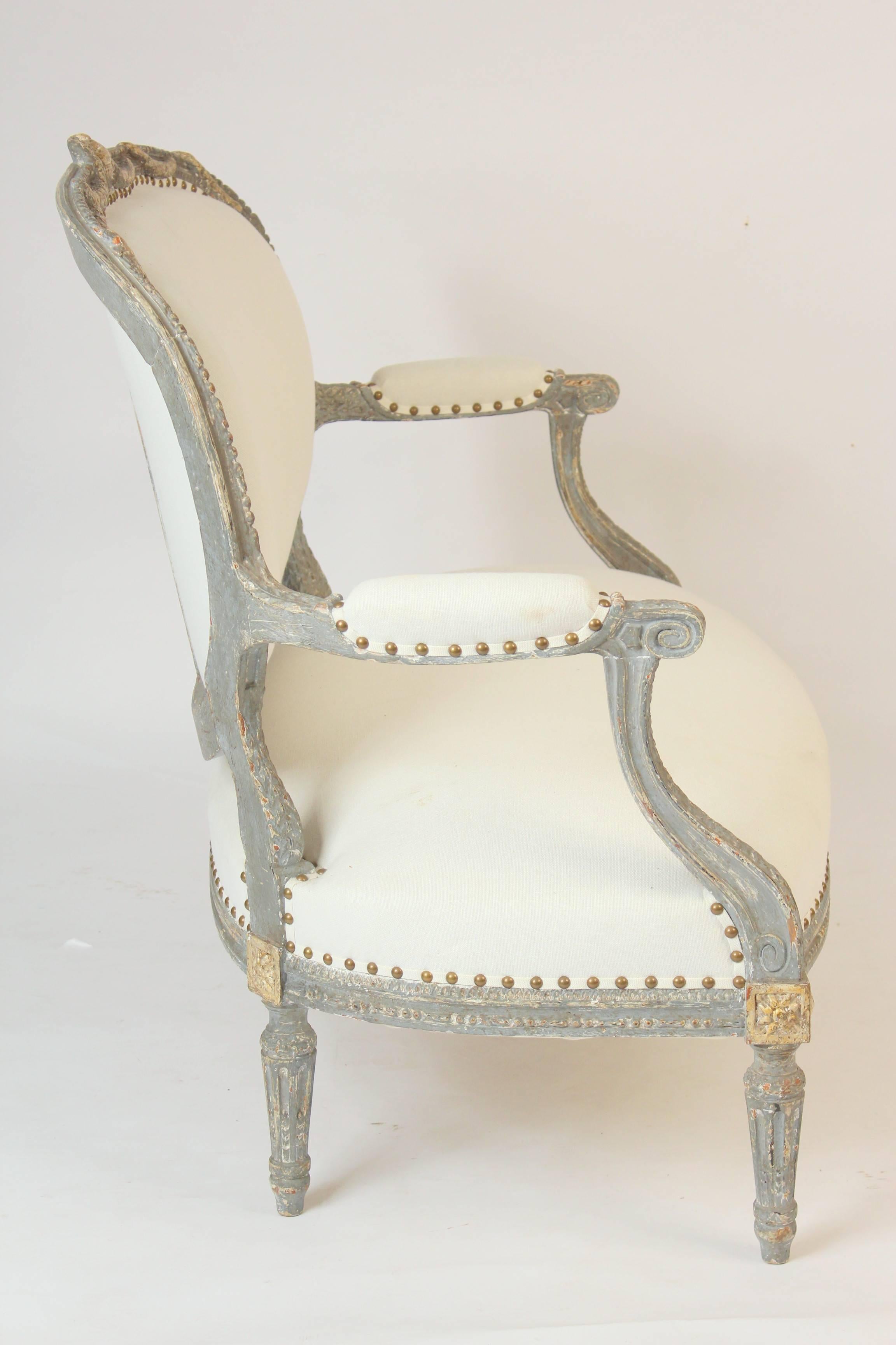 Louis XVI style grisaille painted and partial gilt settee with a swagged carved crest rail, late 19th century. Nice crusty old original paint.
