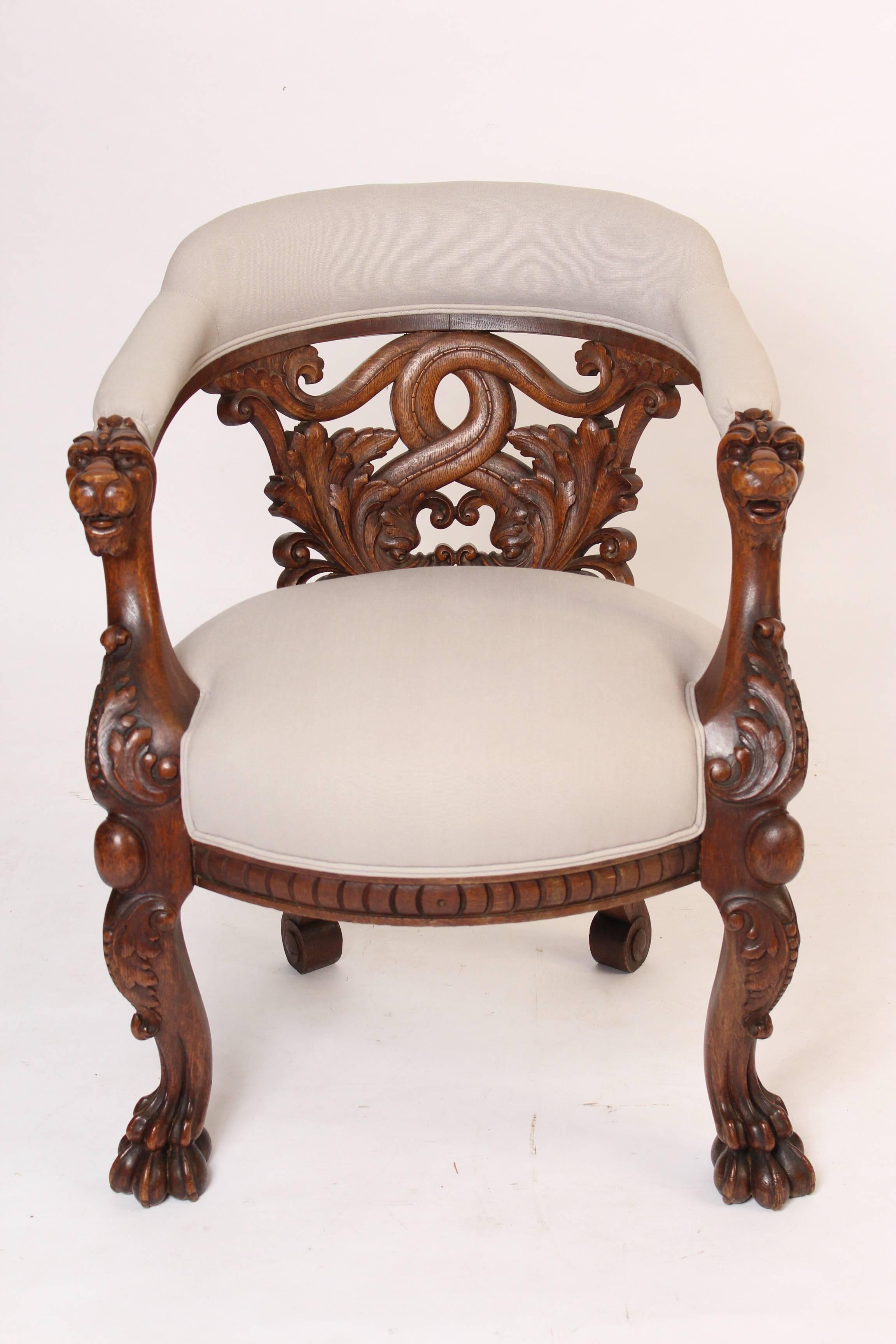 Roux and company barrel back carved oak armchair with foliate carved intertwined back, carved animal form arm terminals and paw feet, circa 1880. Label on bottom of chair reads, Roux and Company, corner 5th Avenue & 20th street, etc. We had this