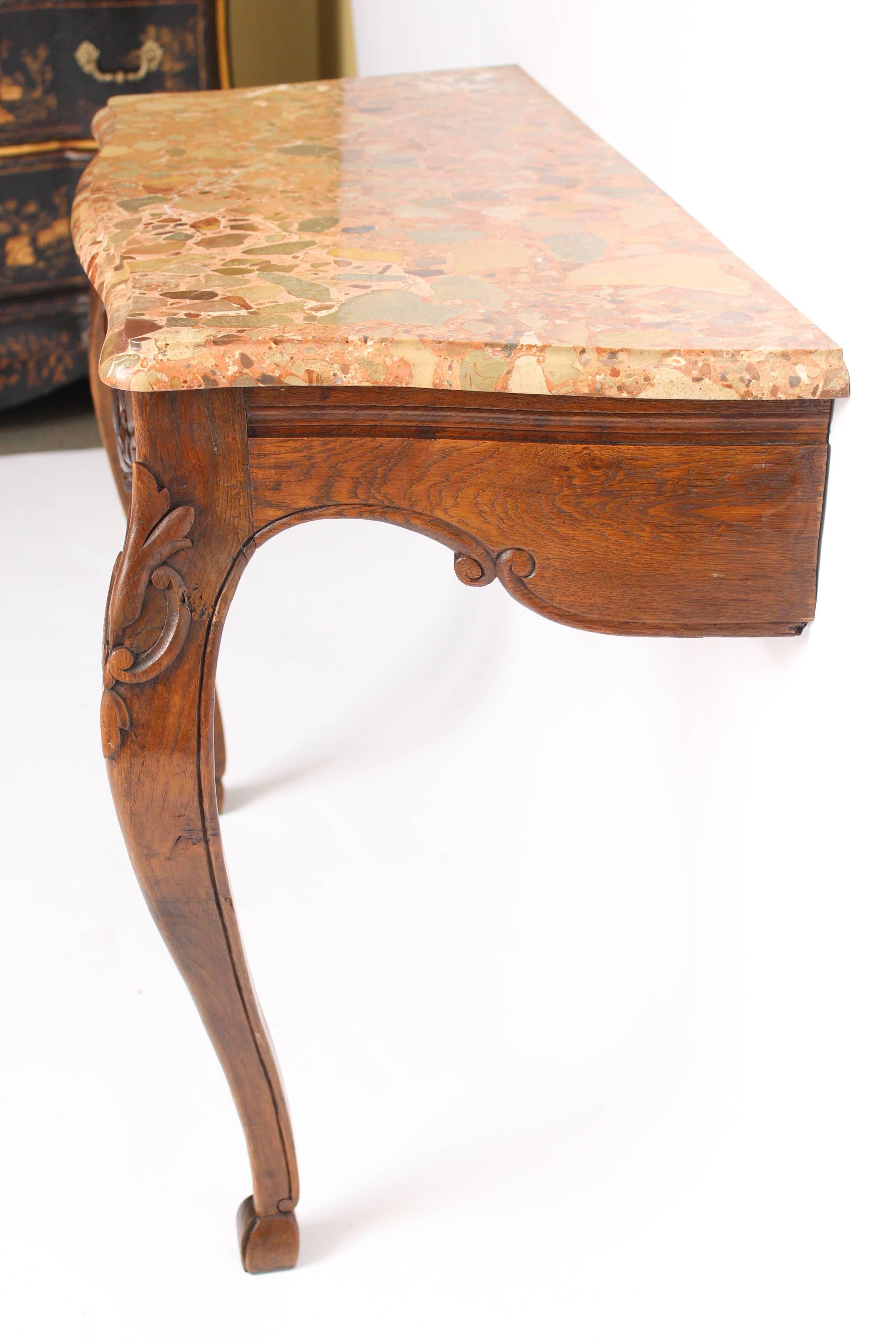 Louis XV provincial style carved oak console table with a marble top, circa 1900.