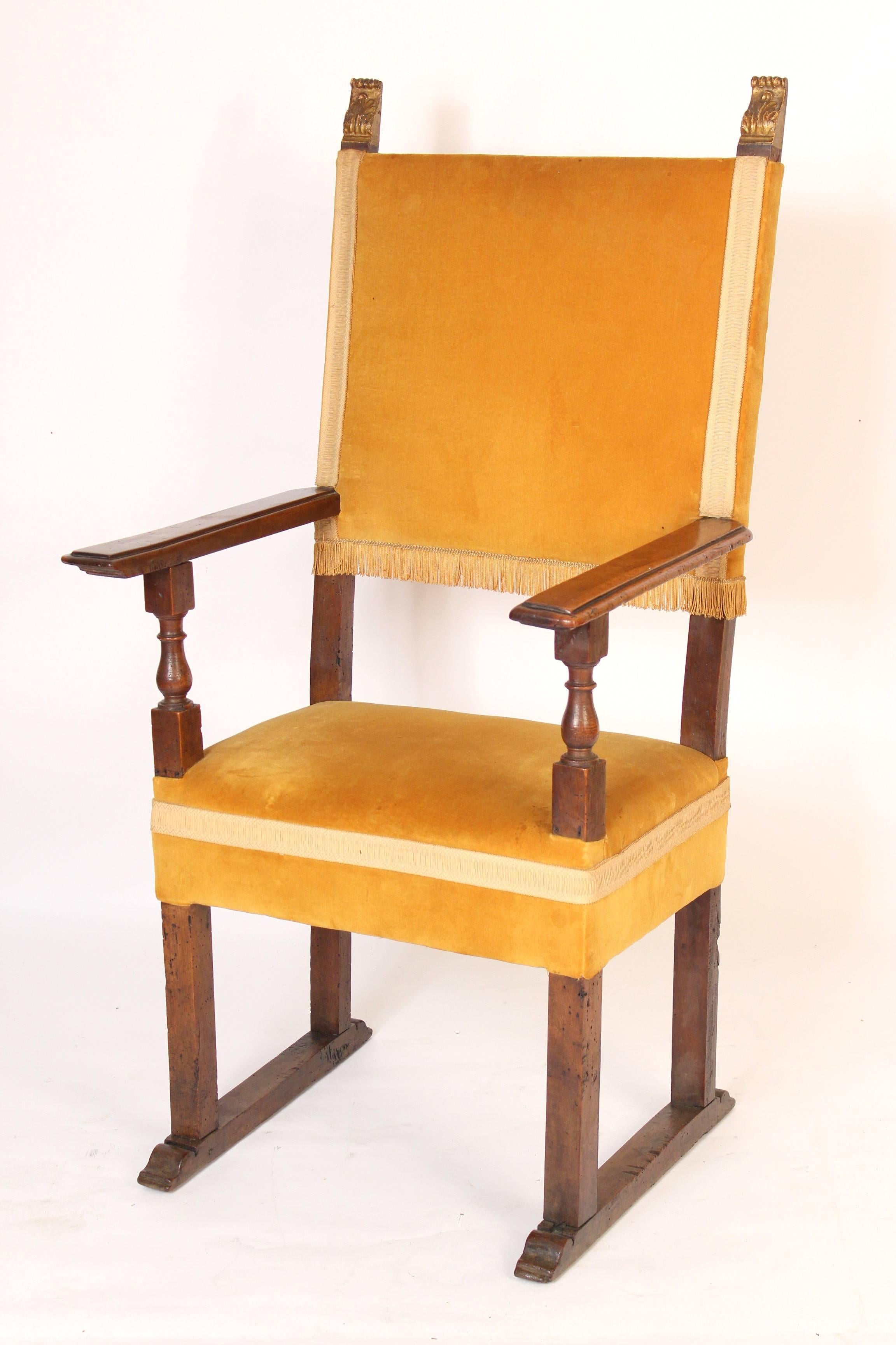 Pair of Italian Baroque style walnut armchairs with gilt finials, one chair is 19th century and the other chair is 20th century.