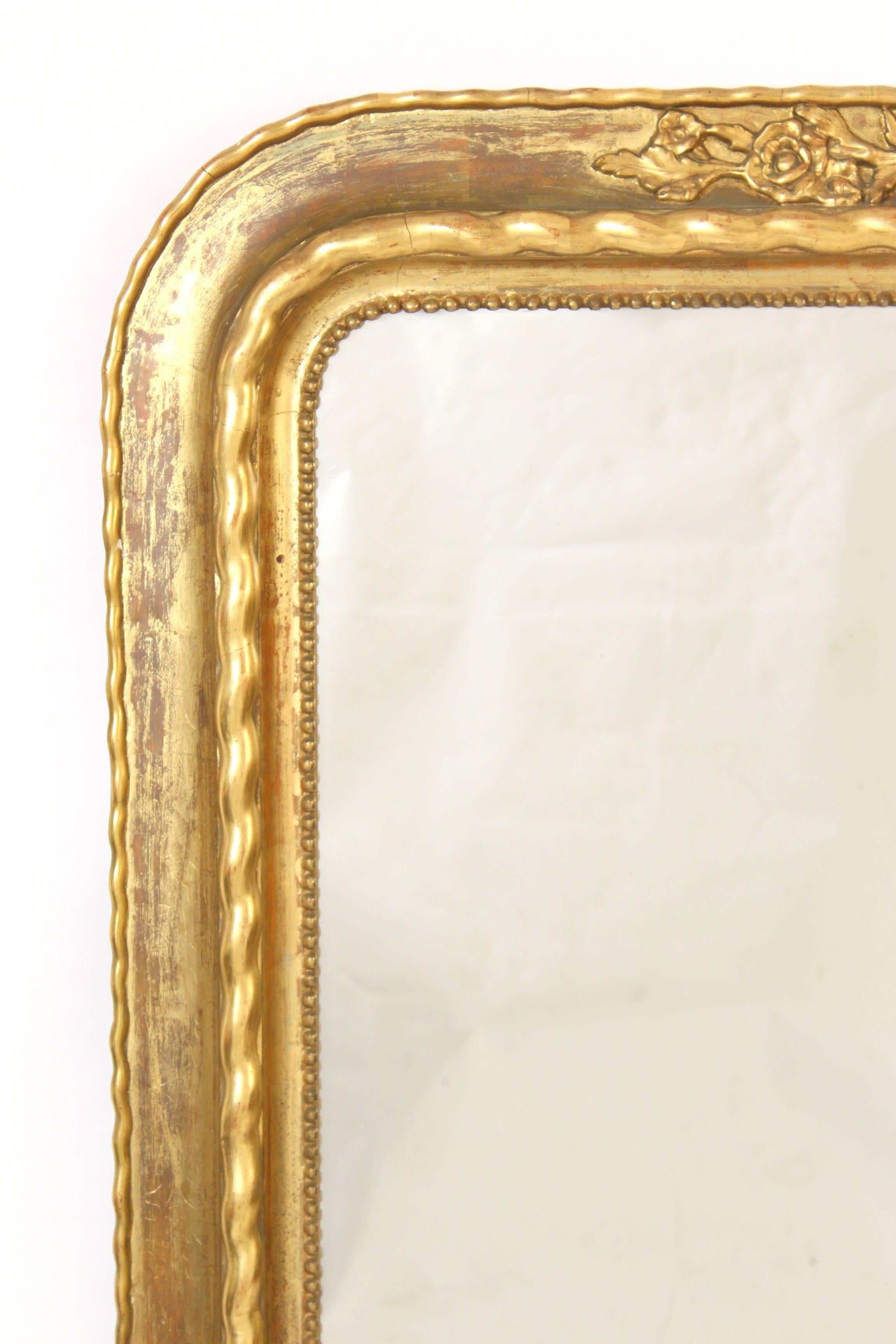 Large Napoleon III style gilt wood mirror, late 19th century. Areas of rubbing on gilding, sizing showing.