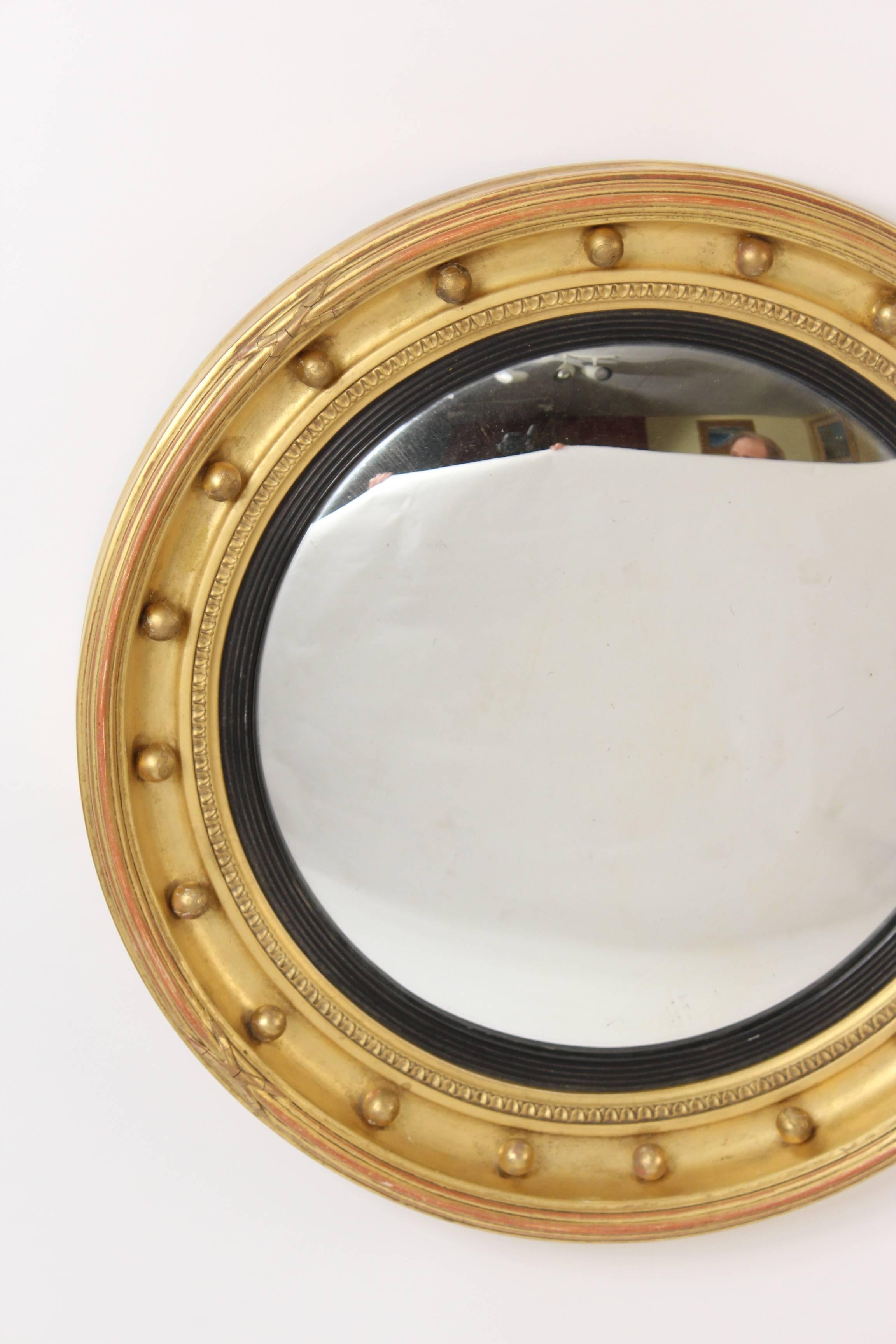 George III style giltwood bulls eye mirror with convex glass, circa 1900. The depth of the mirror is 3