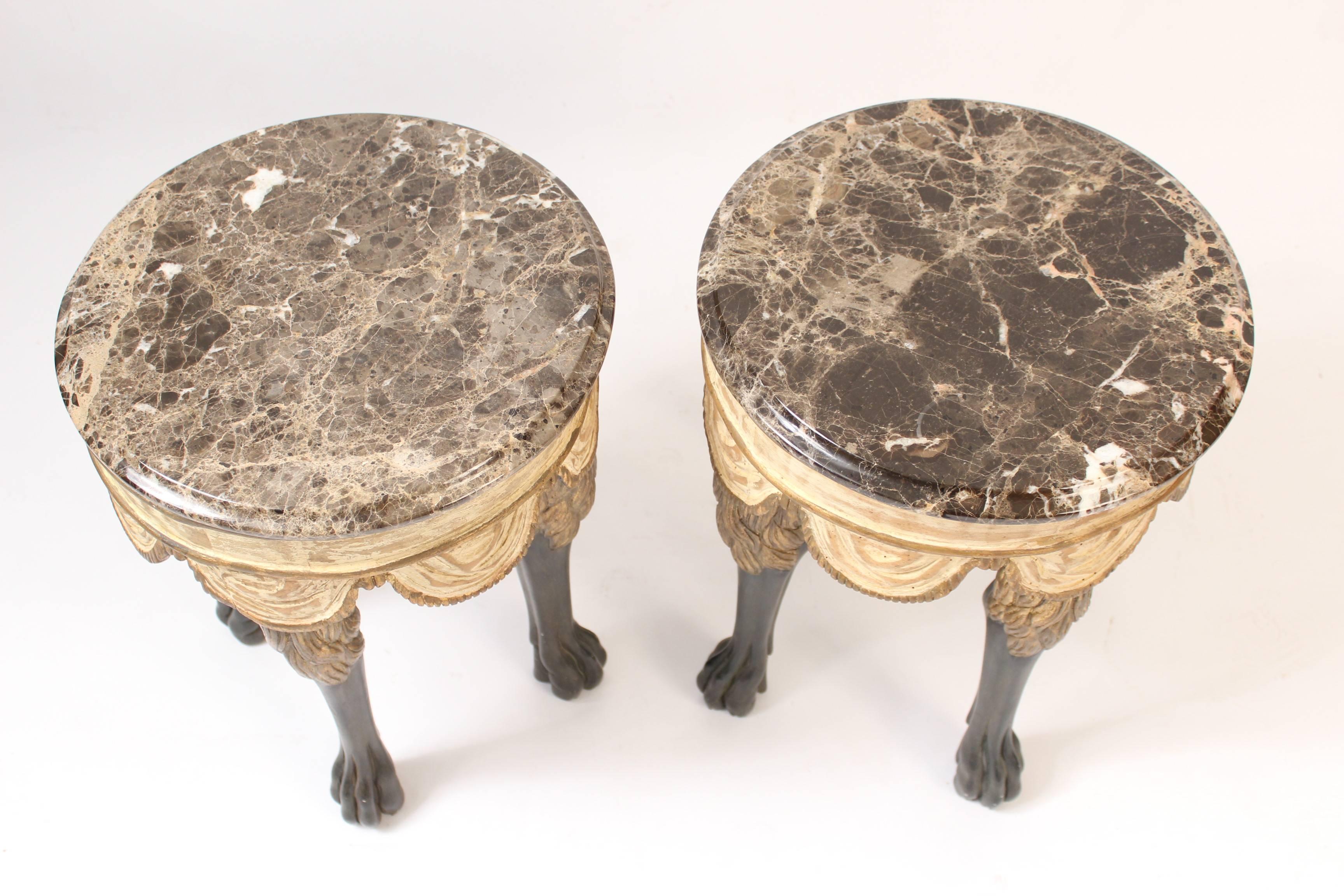 Pair of continental neoclassical style occasional tables with wood carved swag form aprons, gilt and black painted legs and marble tops, made circa late 20th century.