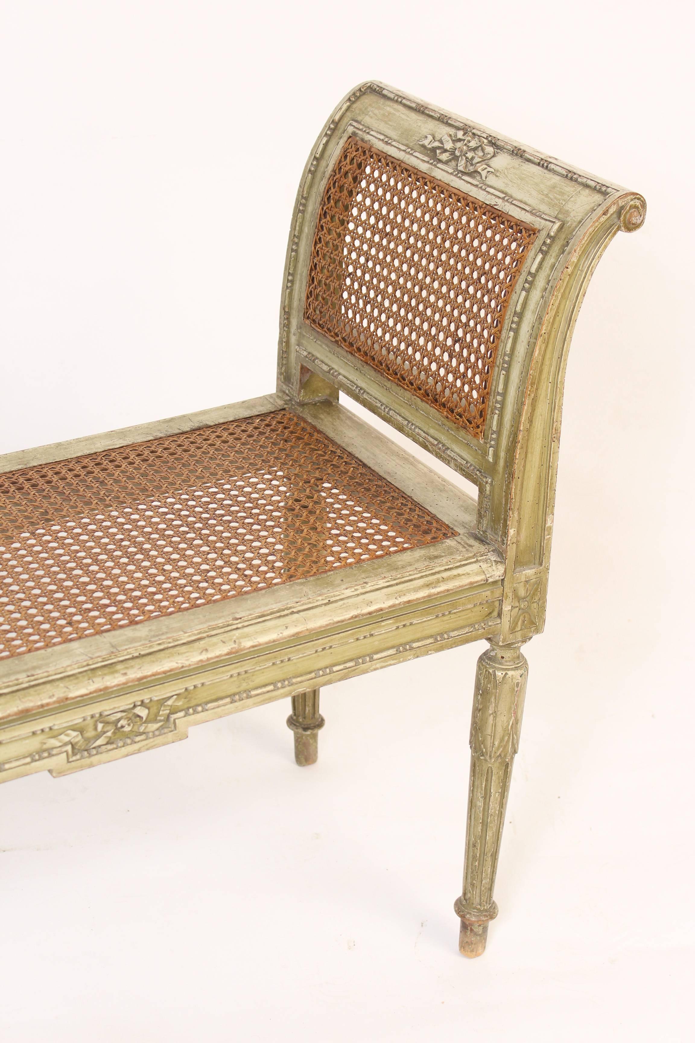 Louis XVI style painted bench with cane sides and seat, circa 1930. 