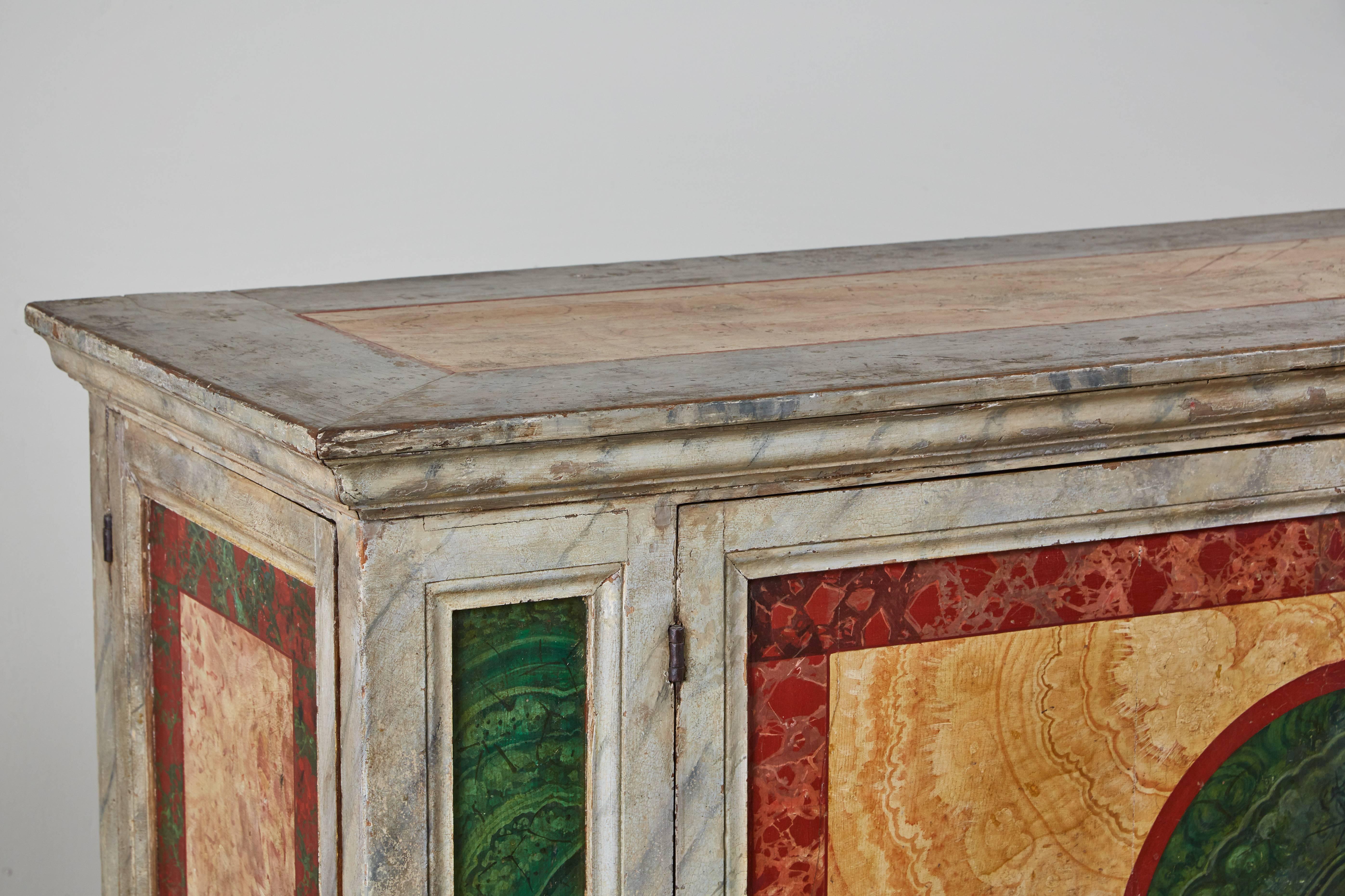 Grand, unusual, two-door, Tuscan buffet on a stepped base. Formerly a church altar, this 19th century piece is richly hand-painted and faux-marbled throughout.