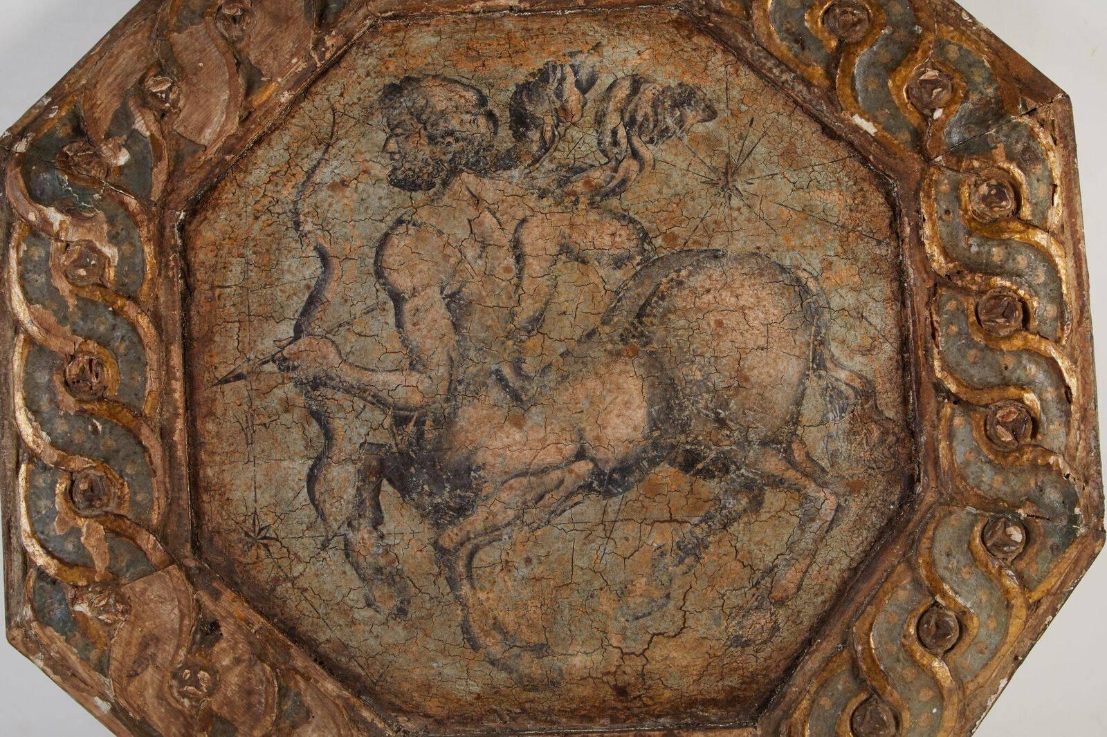 Parcel-gilt, hand-carved and painted, octagonal, Venetian ceiling medallion featuring a galloping Centaur armed with a notched bow. This depiction of the Sagittarius symbol would have originally been part of a series of ceiling medallions that