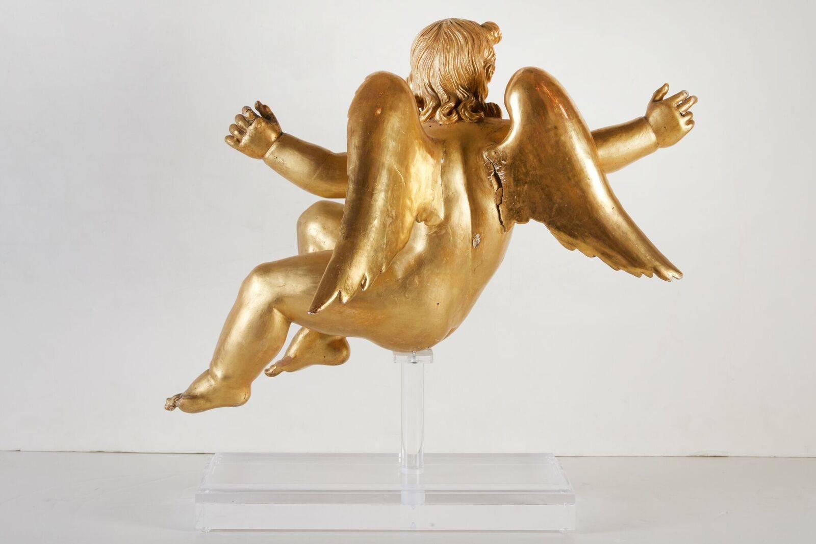 Fine pair of left and right, hand-carved, gessoed and 22-karat gold gilded, angels singing in adoration while in flight. Both later mounted on custom, Lucite stands. Originally from a grand altar.