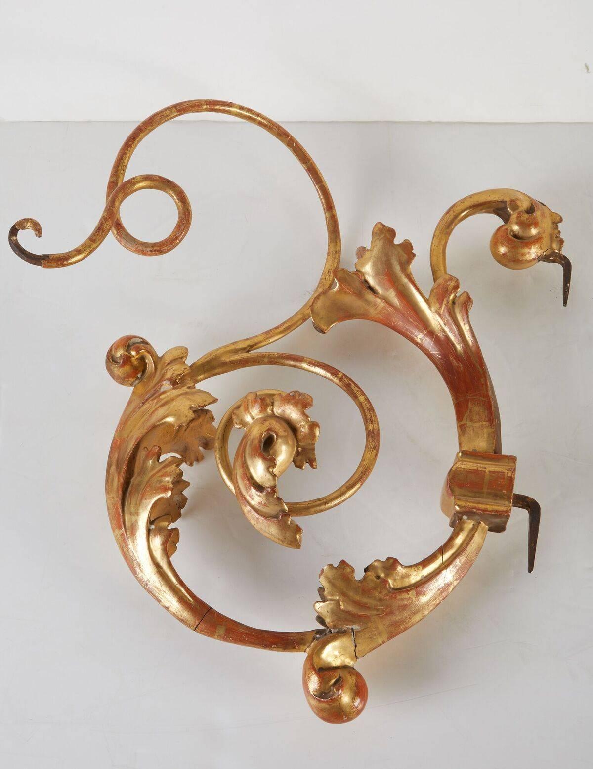 Pair of highly desirable, Italian, circa 1785, scrolling brackets in metal and wood. Both gessoed, and 22-karat gold gilded. The pair embellished with acanthus leaf sculptures and terminating in whirling, tapered tendrils. Initially used to hang
