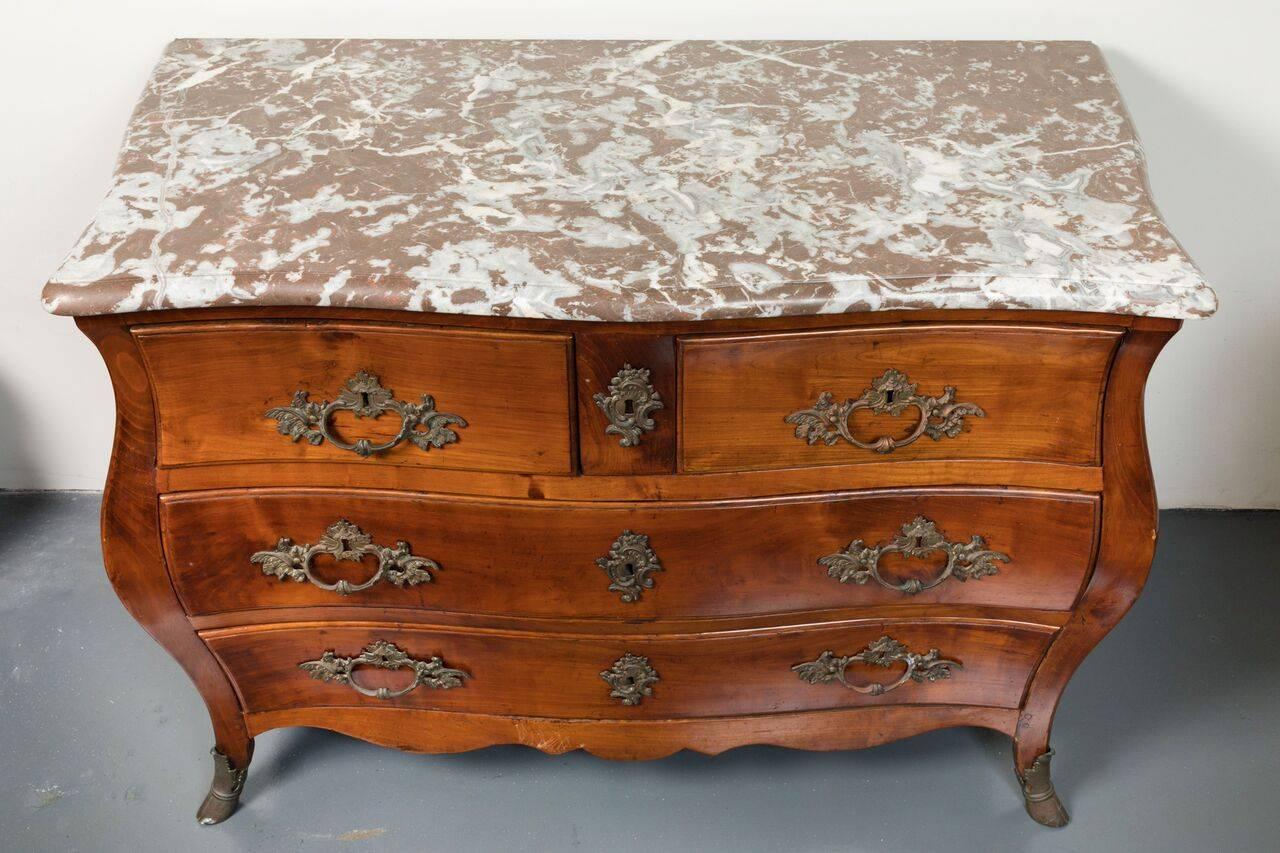 Two-over-two, solid walnut, Bombay style commode from Naples. Chocolate marble top is original to the piece. The whole above serpentine legs with, ormolu-sleeved, hoof feet.