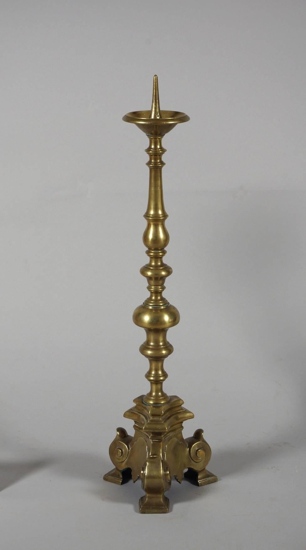 Rare set of four tall brass altar sticks, each with a brass pricket and deep bobeche; the turned stem raised on a triangular base with square feet.

These beautiful candlesticks date to the 18th century, but are in the 16th century style. For a