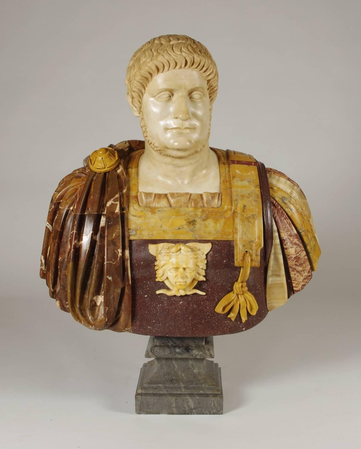 Large marble and porphyry bust of the Roman Emperor Nero, the white marble head set into a porphyry torso adorned with various marbles including Sienna and onyx, on a gray marble socle. Modeled after the ancient original in the Uffizi Gallery,