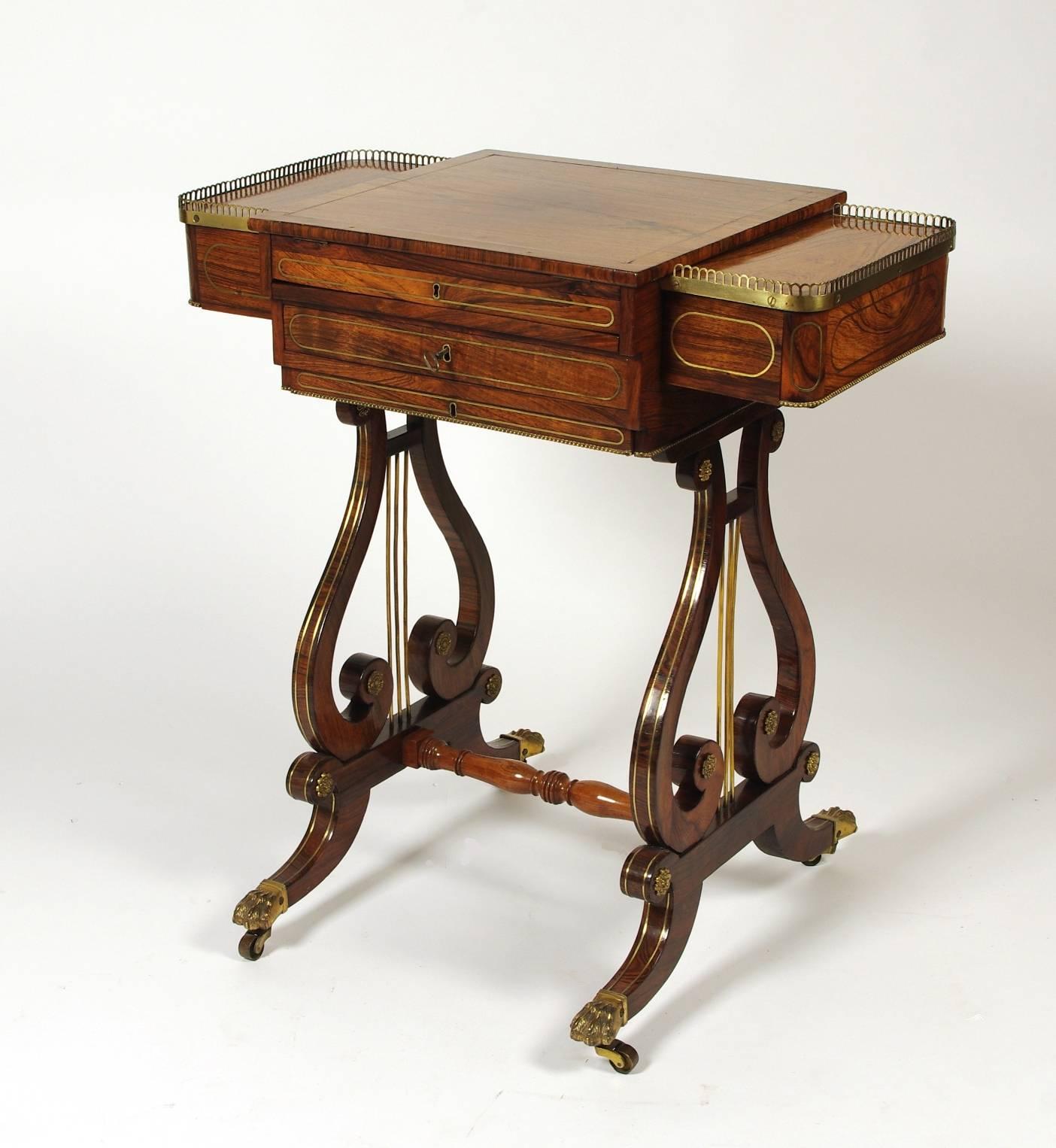 Fine Regency brass inlaid rosewood combination work or games table, the easel top opening to backgammon and chess; the drawers fitted for watercolor supplies; the rectangular ends with pierced galleries and drawers; the lyre supports on out-swept