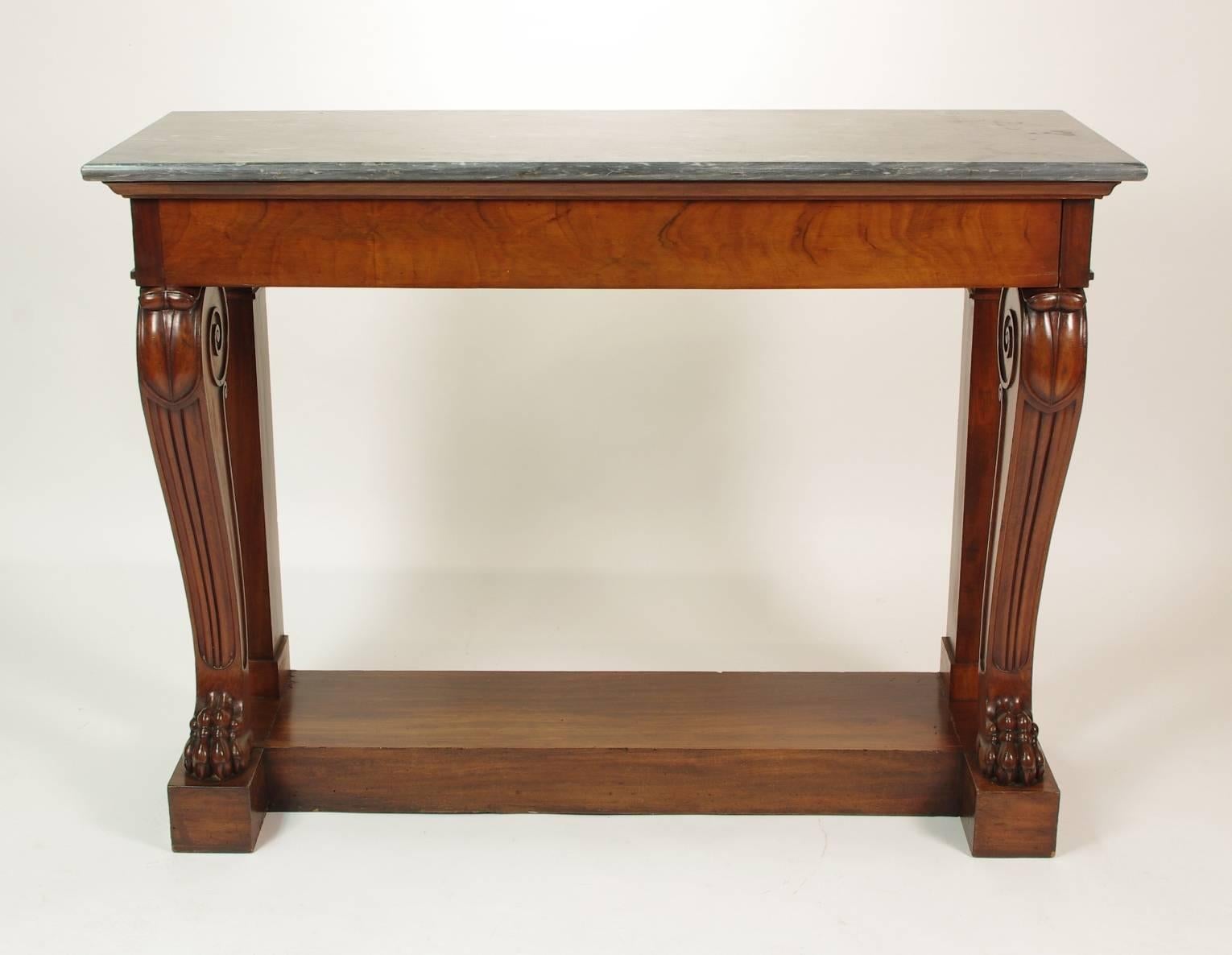 Fine Charles X (Restauration) mahogany console table, the original marble top (Blue Turquin) over the single long drawer; the two reeded uprights with volutes and leaf carved knees ending in paw feet, all on a plinth base. 
Signed, L. BELLANGÉ.