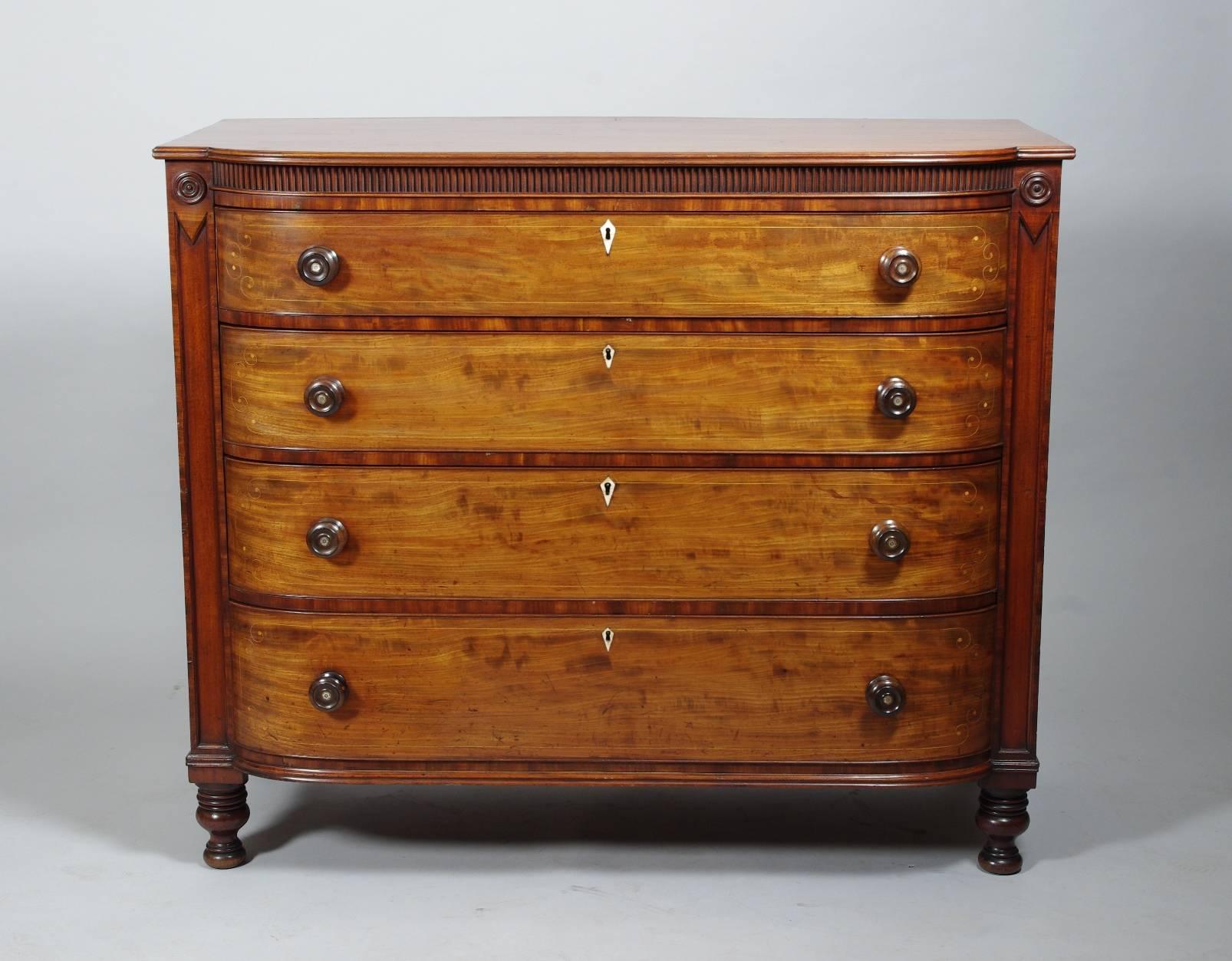 Fine William IV fiddle-back mahogany gentleman's chest of drawers, the rectangular top with an elliptic front and reeded frieze over four long graduated drawers, each with delicate string inlay, bone escutcheon and turned rosewood knobs set with