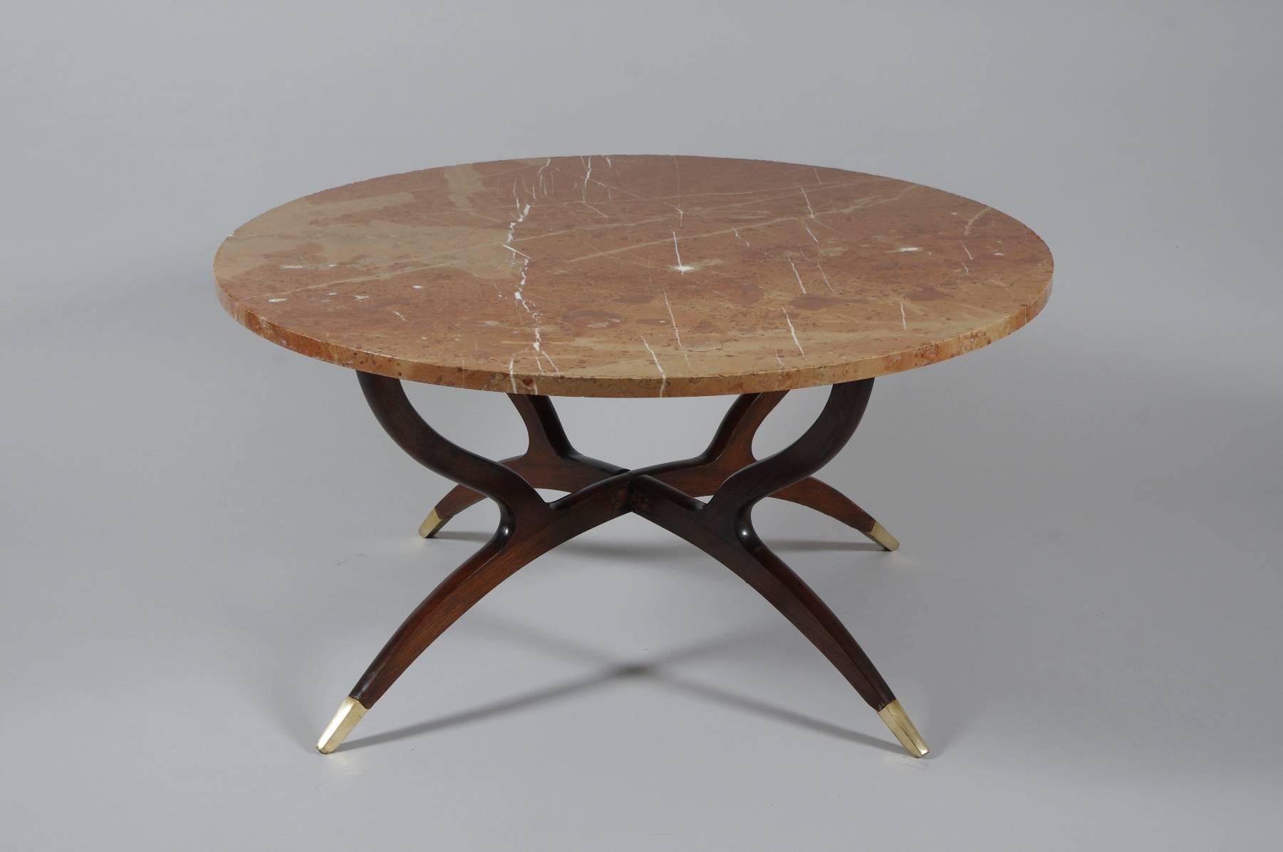 Elegant spider leg coffee table, the rose marble top on a folding curvilinear base with brass feet, reminiscent of Carlo de Carli.

Similar examples of this coffee table abound on 1st dibs, though none have a marble top. Some with brass trays are