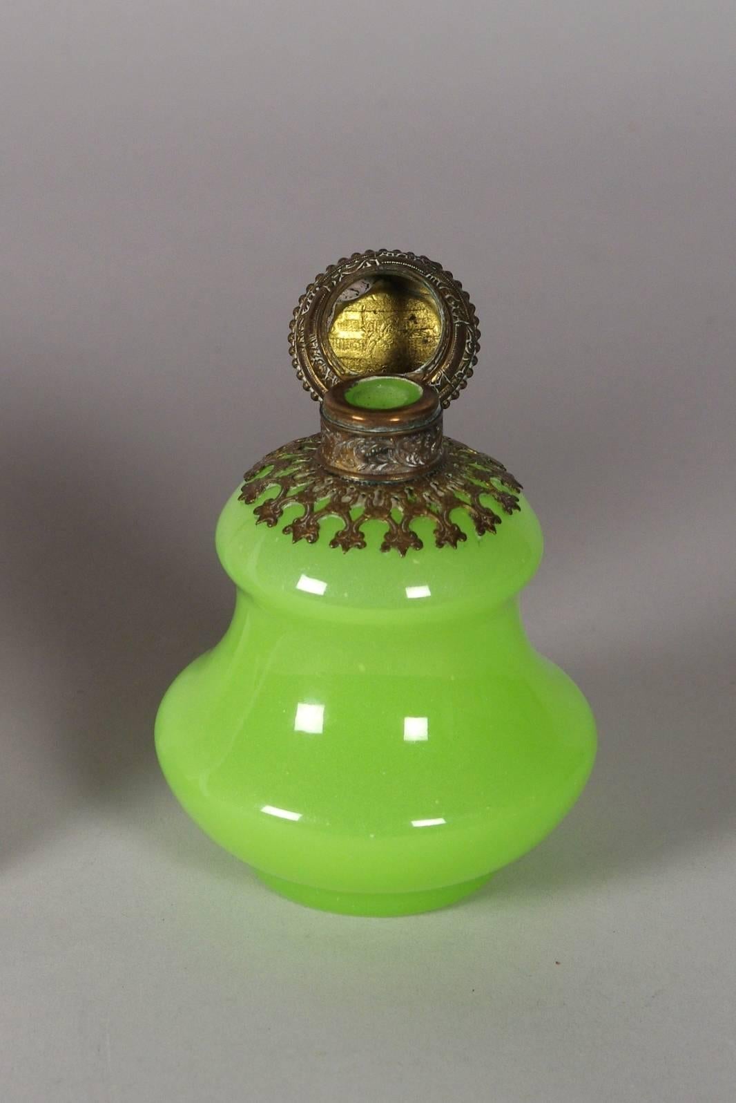 Green opaline pagoda shaped perfume bottle with ormolu mounts. Stopper missing. With its smooth polished surface, luminous color and sophisticated pagoda-like shape, opaline of this quality is often attributed to the Baccarat factory. The fine
