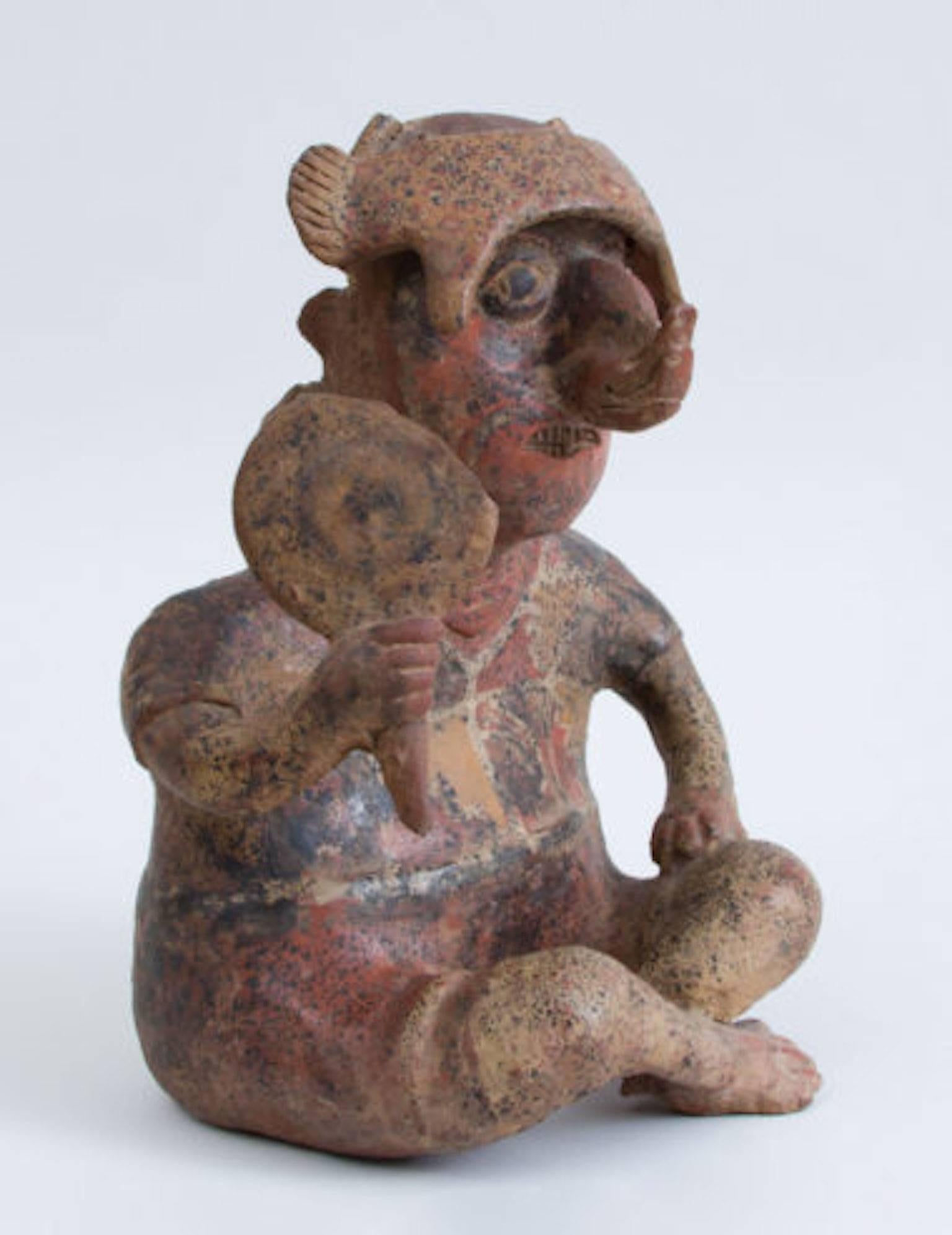 With raised knees, fan in the right hand, ear and nose ornaments headdress and black, red, and yellow pigment, small losses on fan, Pre-Columbian (before 1492) Proto-Classical (50 BC – 250 AD), traces of exhibition number on base, From Nayarit,
