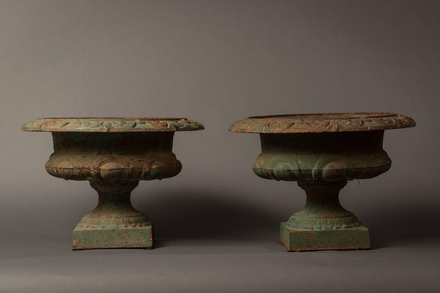Pair of French iron urns with nice age and patina.