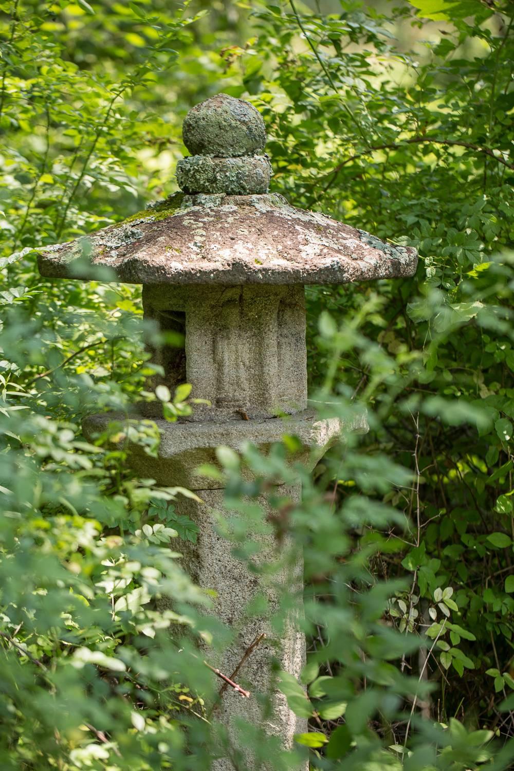 18th century Japanese carved stone lantern, with bas relief figures.