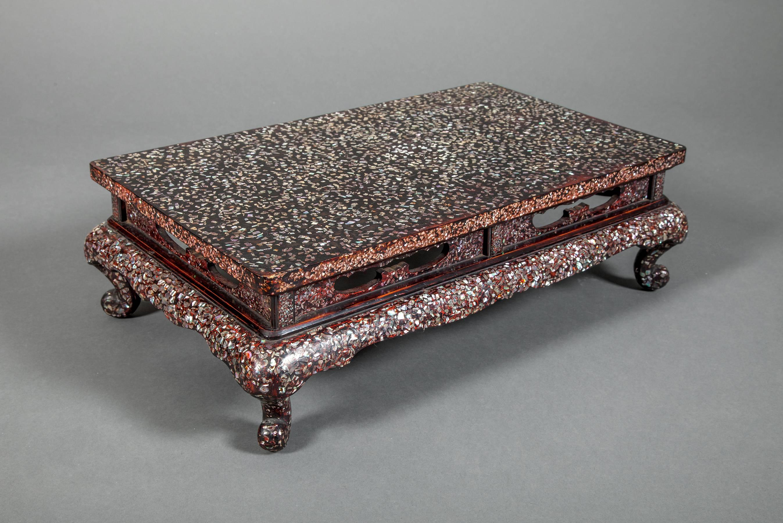 Japanese lacquered wood table
(in Chinese style) with m.o.p. inlay.