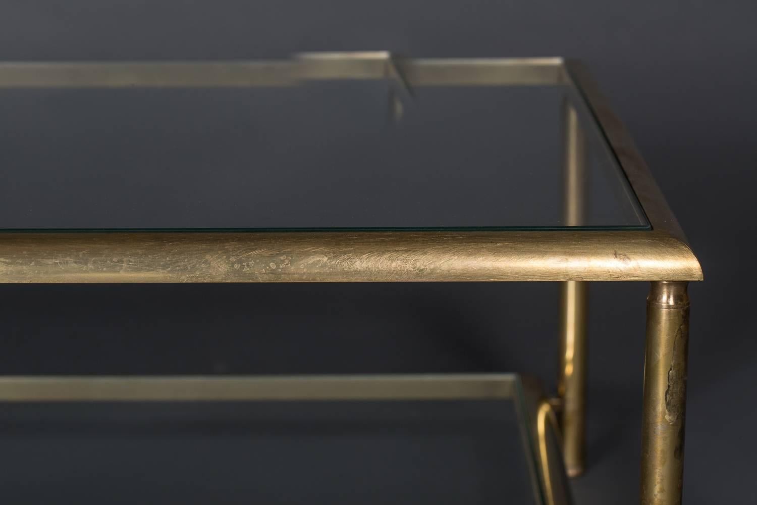 Brass two-tier cocktail table.