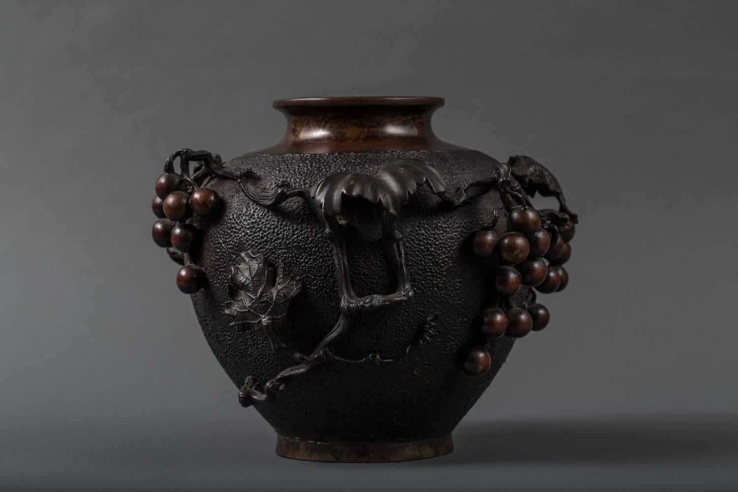 Japanese Bronze Grape Vine Vase with intricate raised design.  Signature reads 