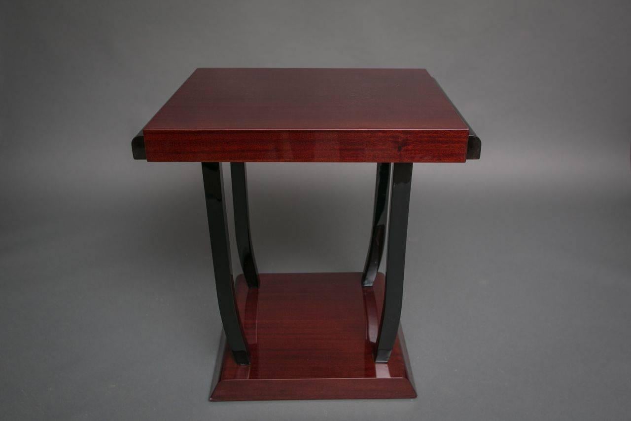 French Art Deco mahogany lacquer table with ebonized legs.