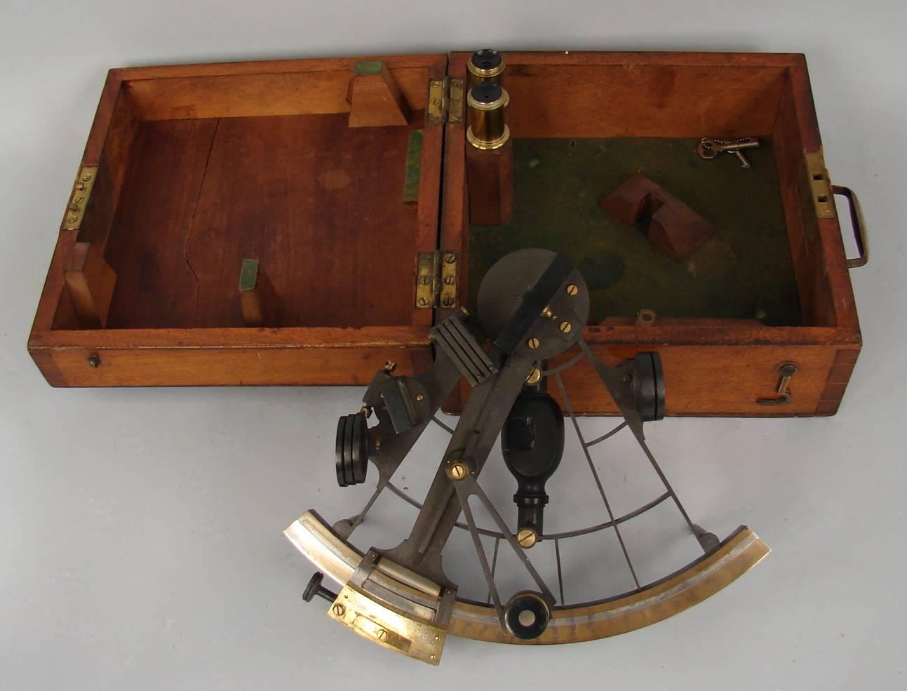 An English bronze and silver sextant made and signed by Elliott Brothers, London, circa 1890. With accessories and its original mahogany case with key.