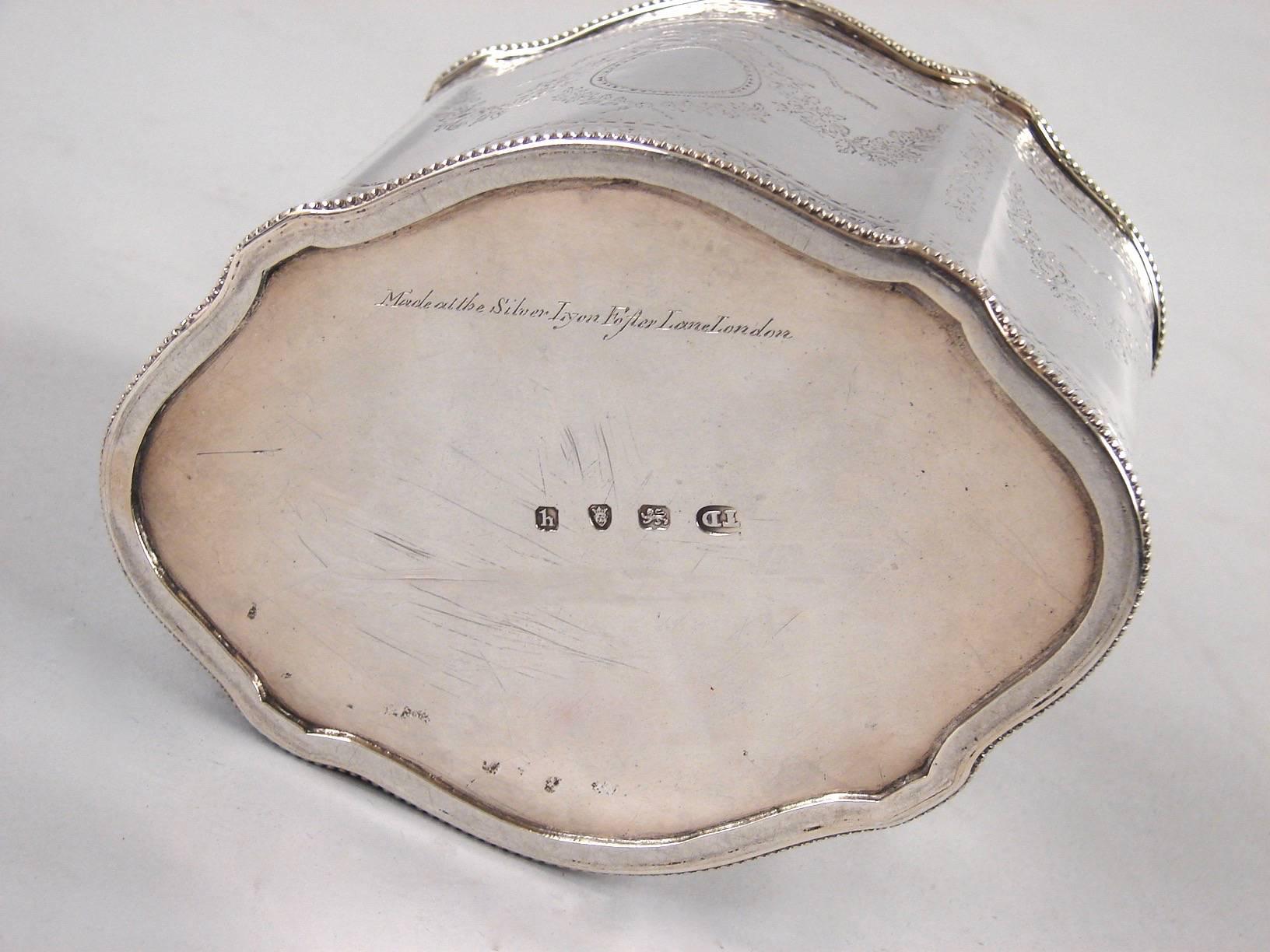 A fine English George III period sterling silver tea caddy of shaped oval form with bright cut decoration fully hallmarked for London 1783-4 by Thomas Daniell and signed in script 
