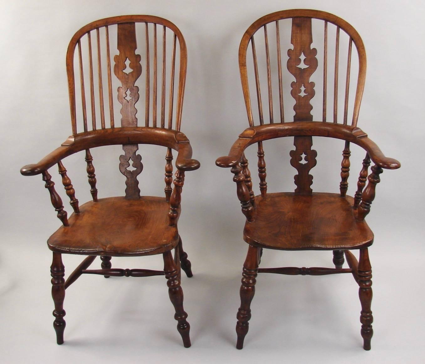 A nice harlequin set of eight elm, ash and hickory broad arm high back Windsor armchairs, some with single 