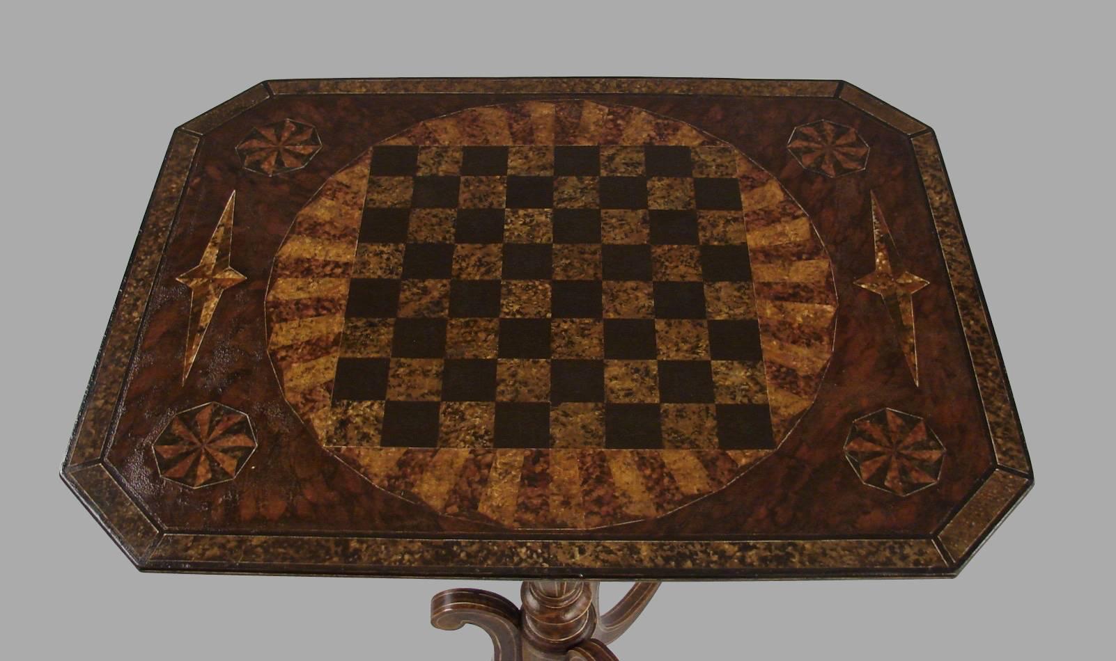 An English Victorian period faux grain painted games table with a chess board top above a partial gilt and painted stylized tripod base, circa 1865.