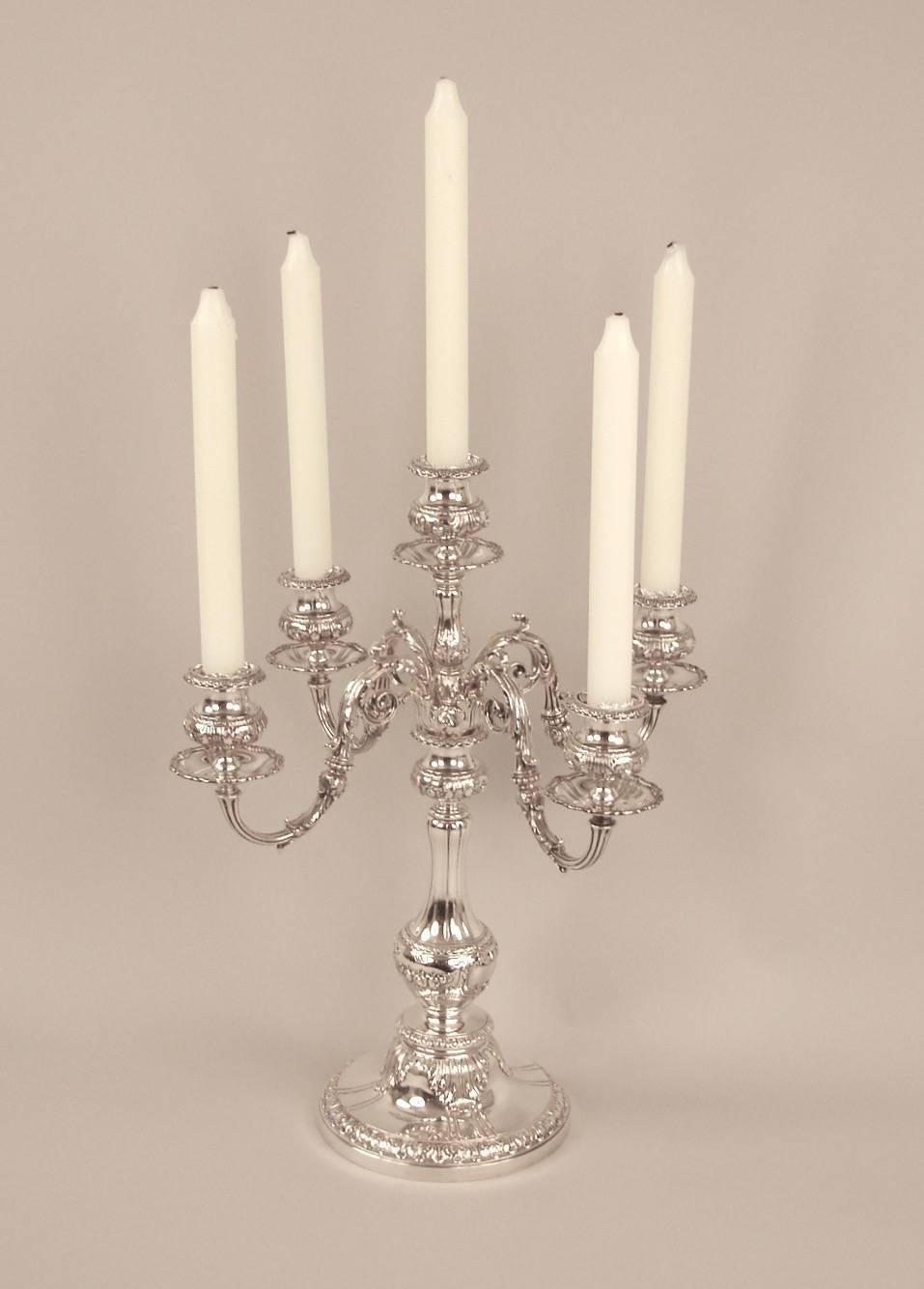 An impressive pair of early 2oth century Gorham sterling silver convertible five-light candelabra in the Renaissance Revival style, each mounted with scrolling supports and accented with sculpted and hammered acanthus leaves, raised on circular