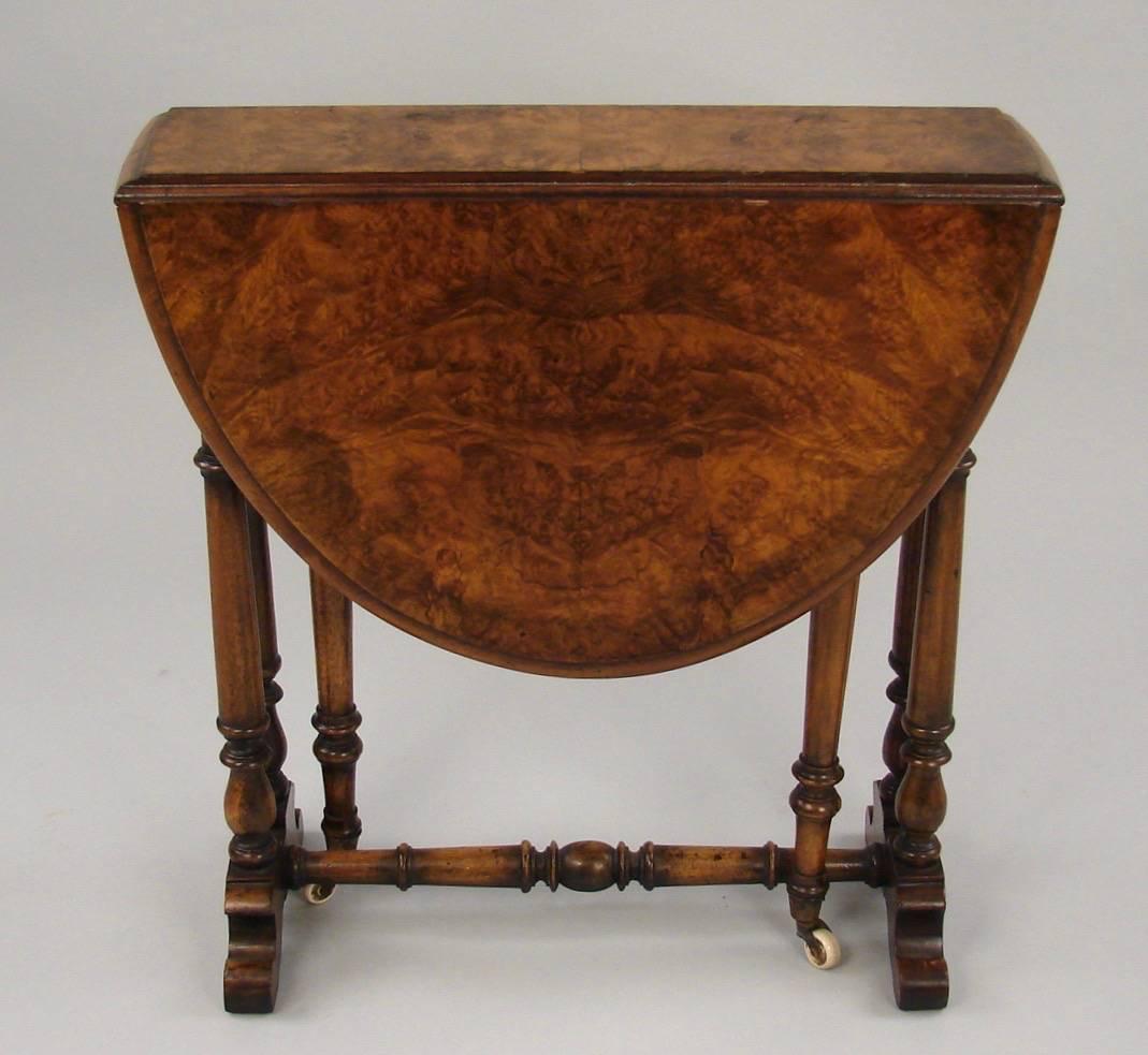 A charming unusually small burl walnut Sunderland action table, the moulded top with drop sides supported on turned legs ending in porcelain casters, circa 1870.