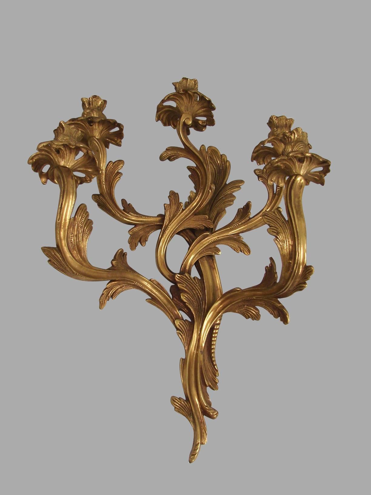 A pair of Louis XV style brass five-light sconces, 20th century. Not electrified.