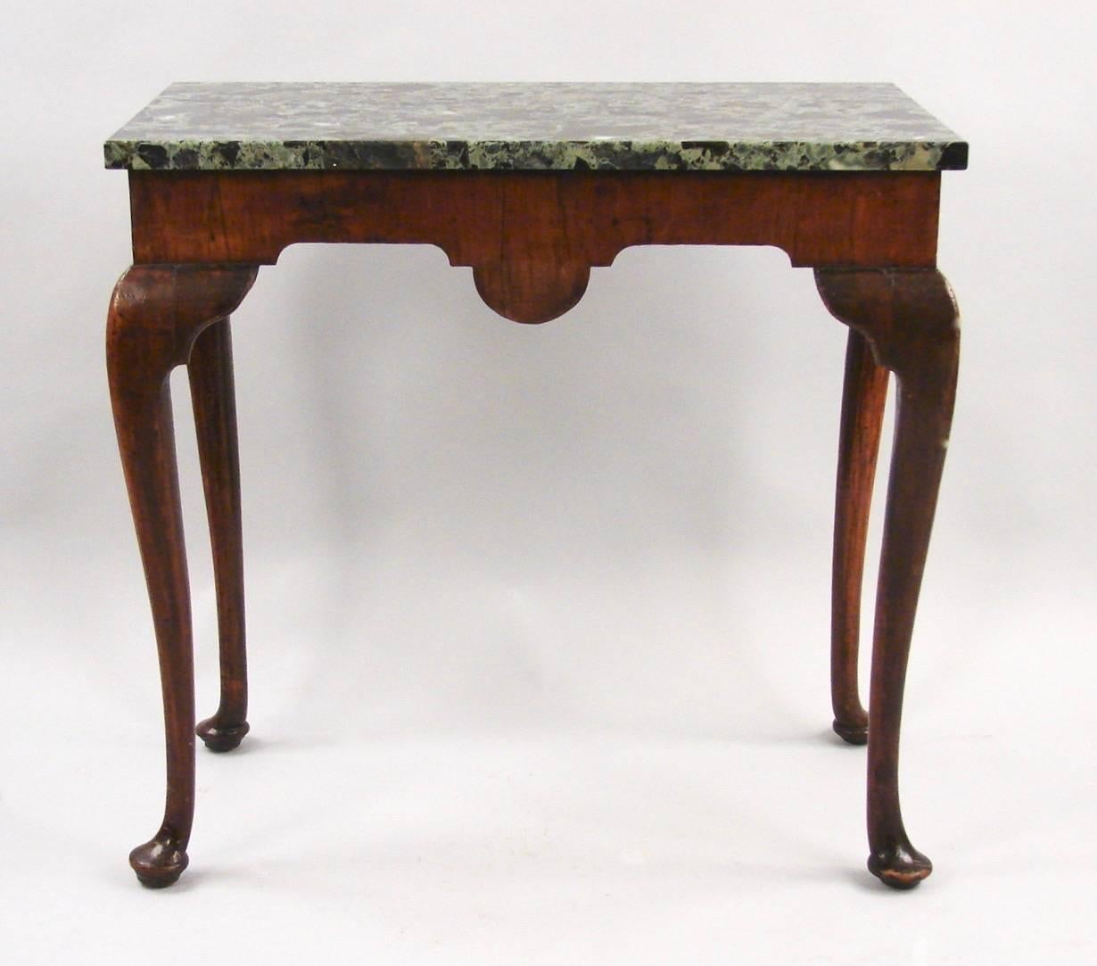 A pretty George II period Irish walnut side table, the replaced green marble top above a carved shell supported on cabriole legs with carved knees ending in pad feet. Excellent old color and patina. Reverse is finished so the piece may be used as a