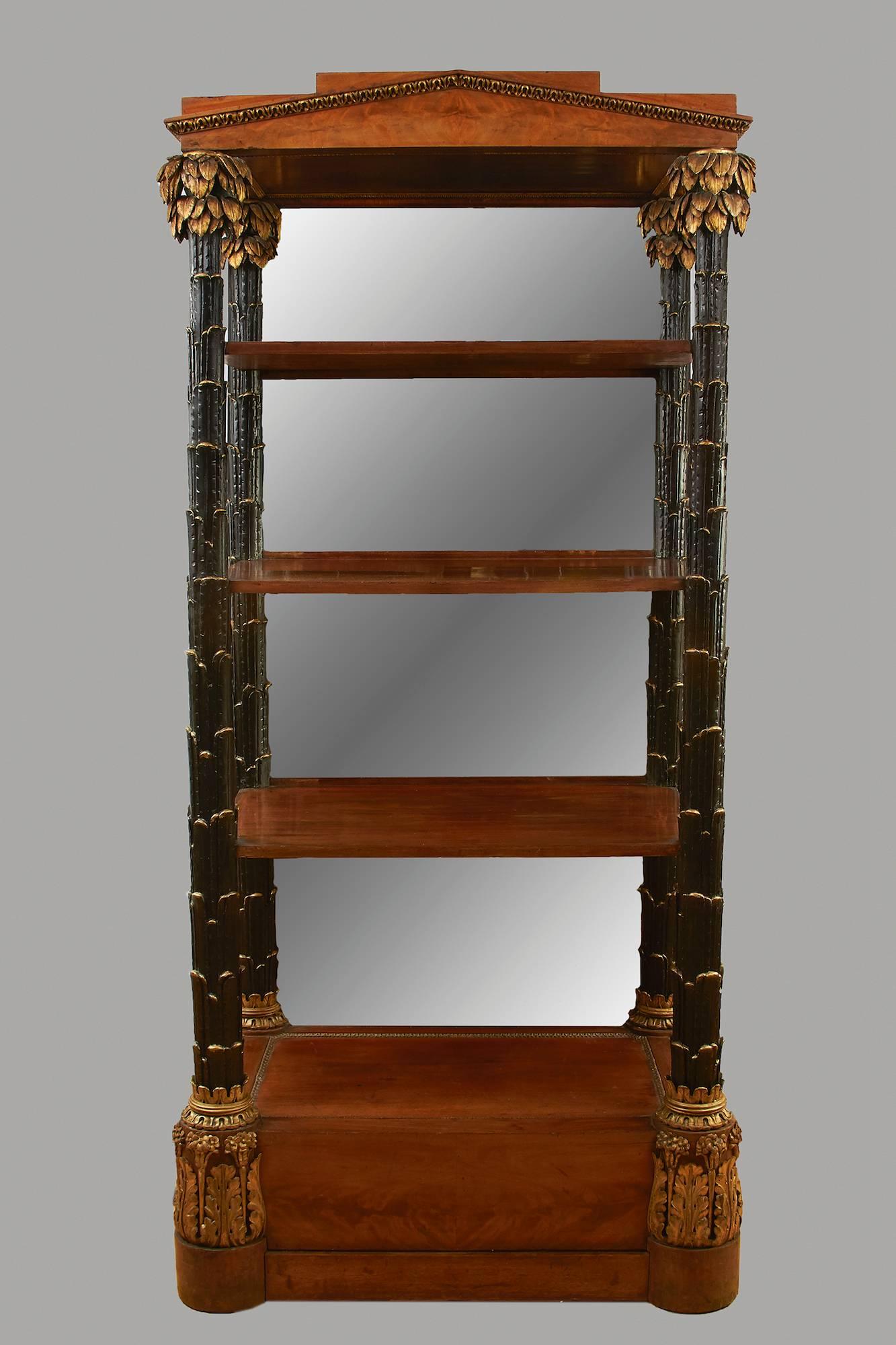 A magnificent and impressive ebonized and parcel-gilt pale mahogany etagere of architectural form, the parcel-gilt pediment supported by four columns of organic form with carved leaf capitals, supporting three shelves, the back inset with mirrors,