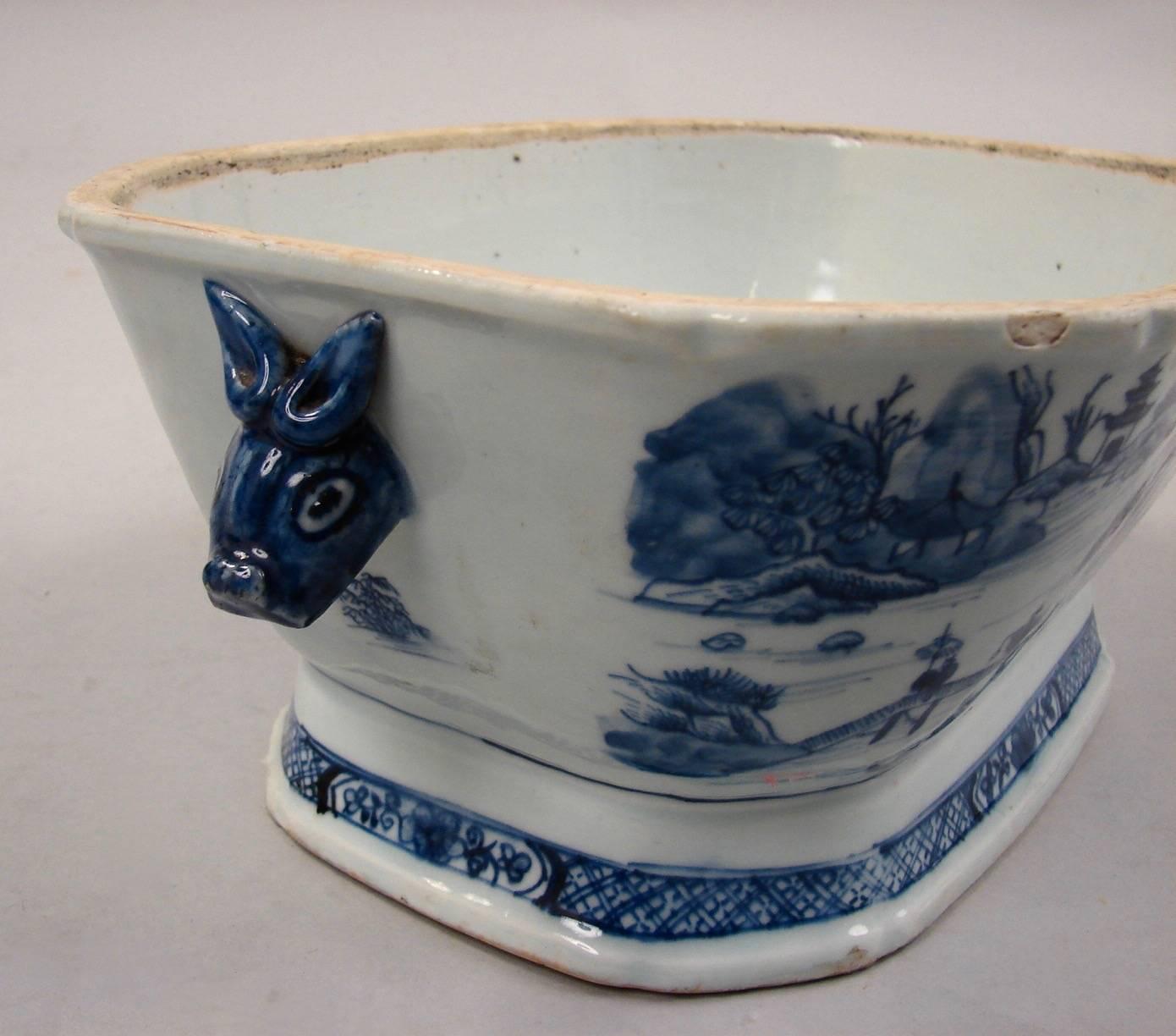 A good Chinese export Canton blue and white soup tureen and cover decorated overall with figures, trees and structures in a river setting, on an associated underplate, the tureen with boar's head handles, circa 1850.