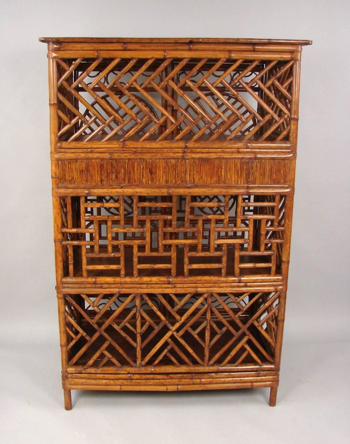 A stylish Chinese bamboo cabinet of traditional design, the two exterior doors with well-executed geometric panels opening to reveal an interior with shelves and drawers. Side and back with similar construction details as the front.