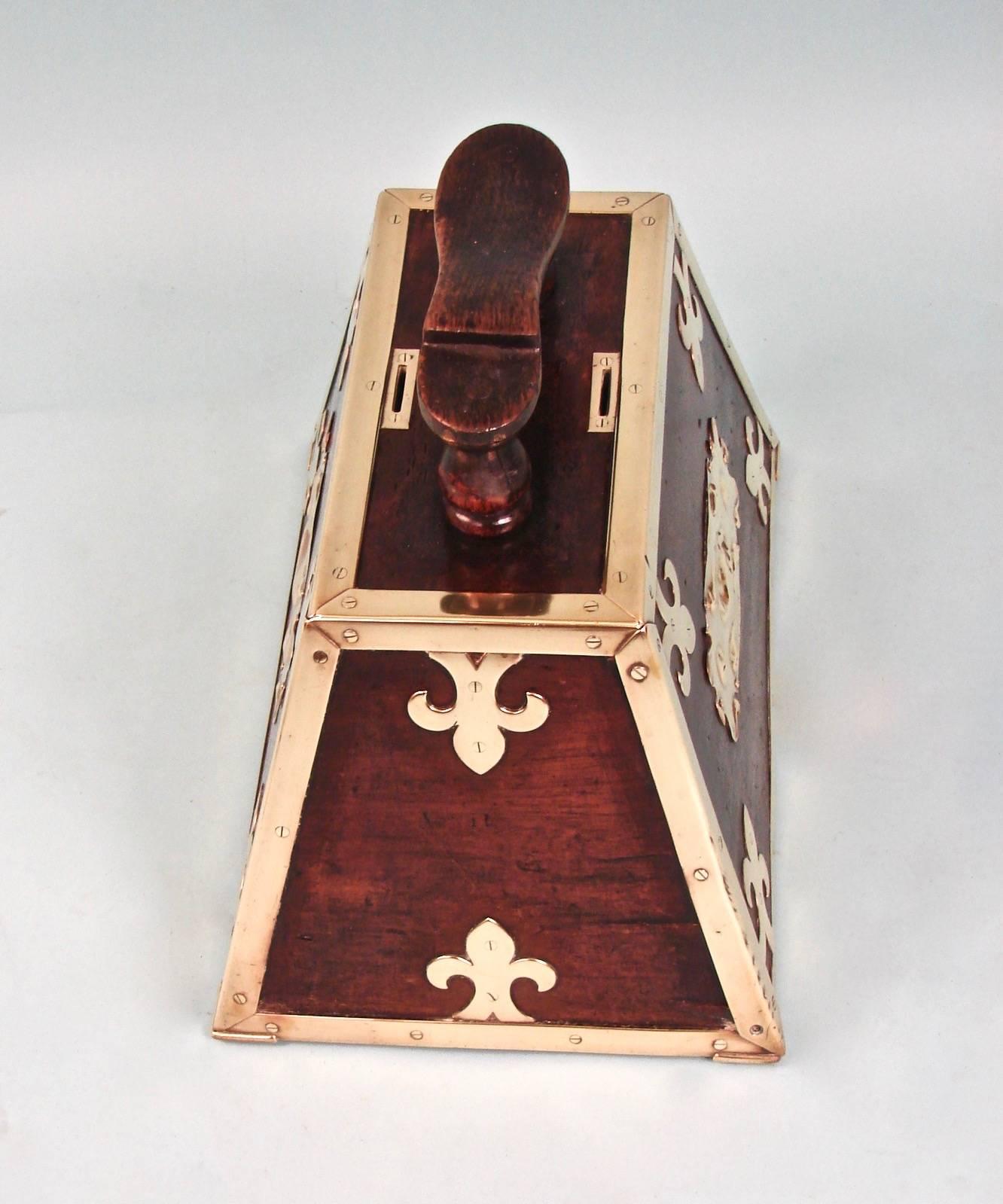 A wonderful Turkish brass-mounted mahogany Art Nouveau period shoe shine box of trapezoidal form. This is a fine example of a street vendor's original shoe shine kit with top mounted coin slots and a locking door.